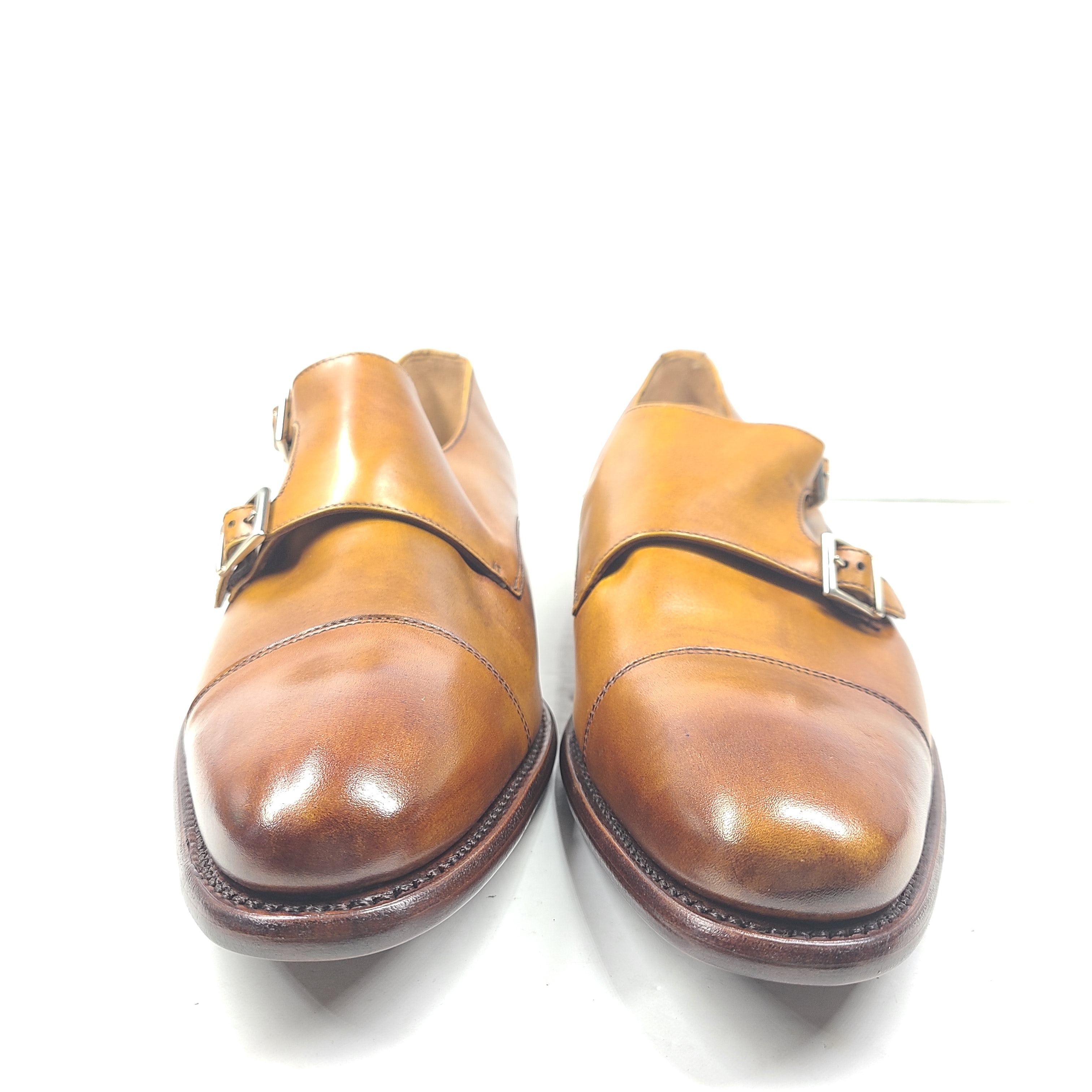 Brown Goodyear-welted leather dress shoes with a refined rounded silhouette and stacked heel.