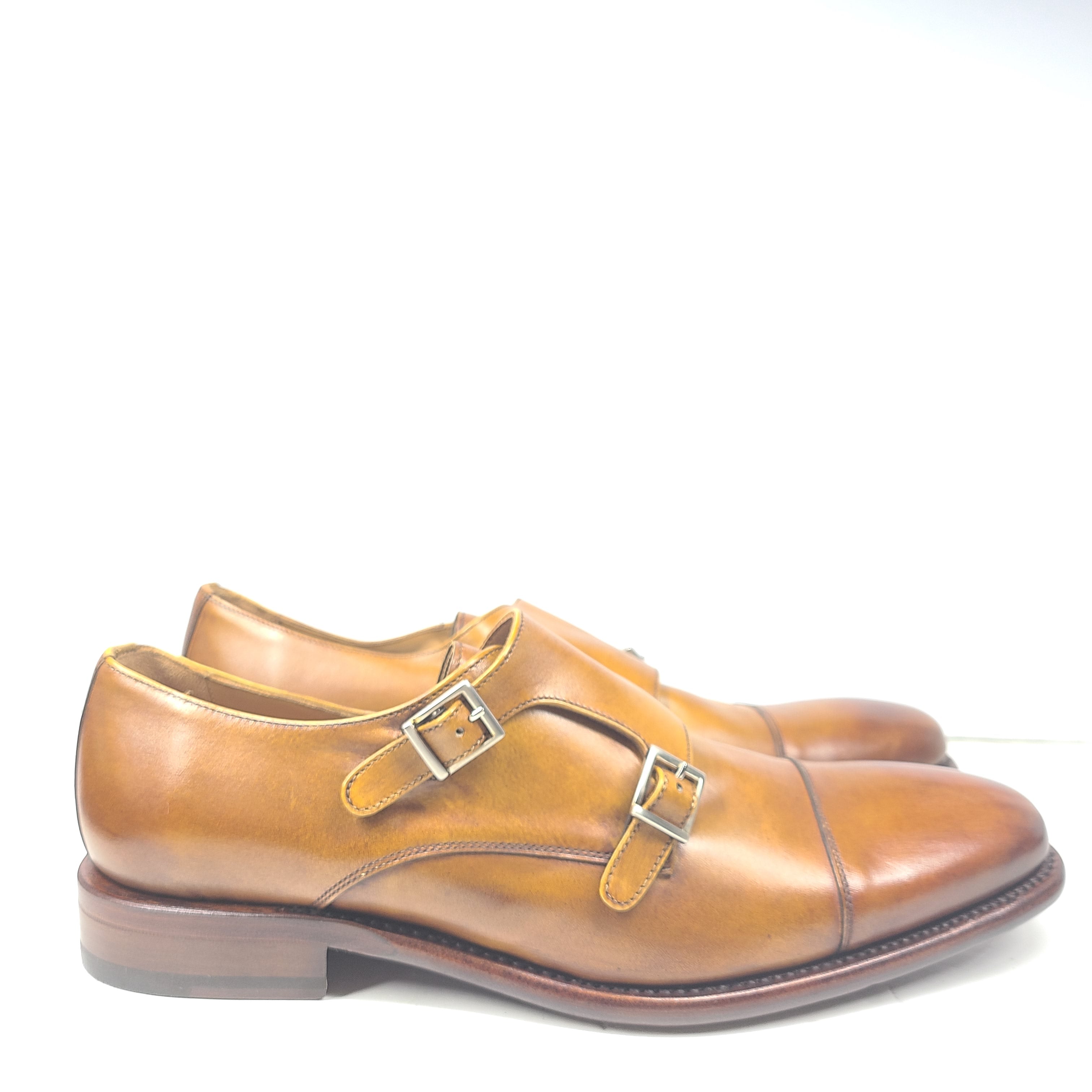 Brown Goodyear-welted leather dress shoes with a refined rounded silhouette and stacked heel.