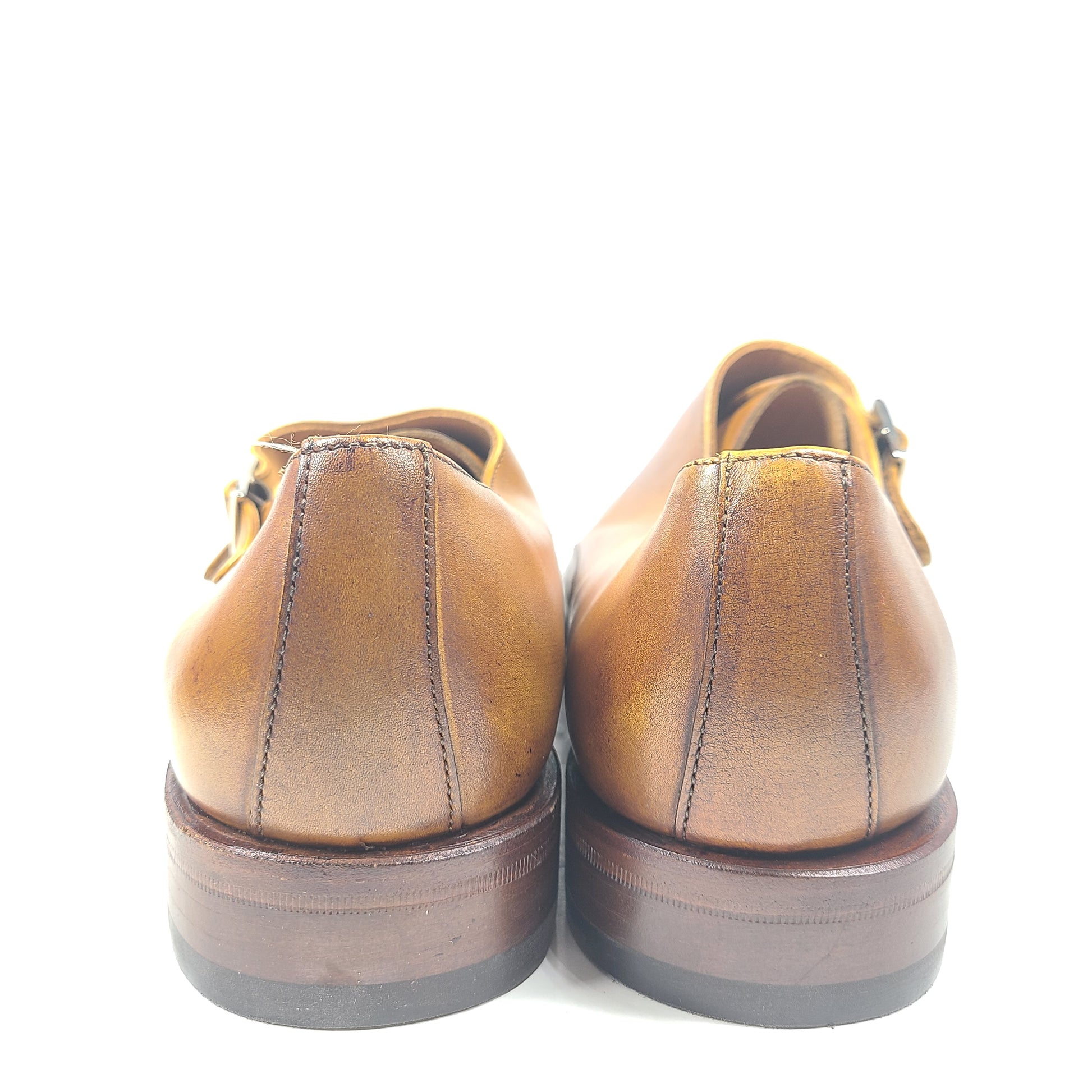 Brown Goodyear-welted leather dress shoes with a refined rounded silhouette and stacked heel.