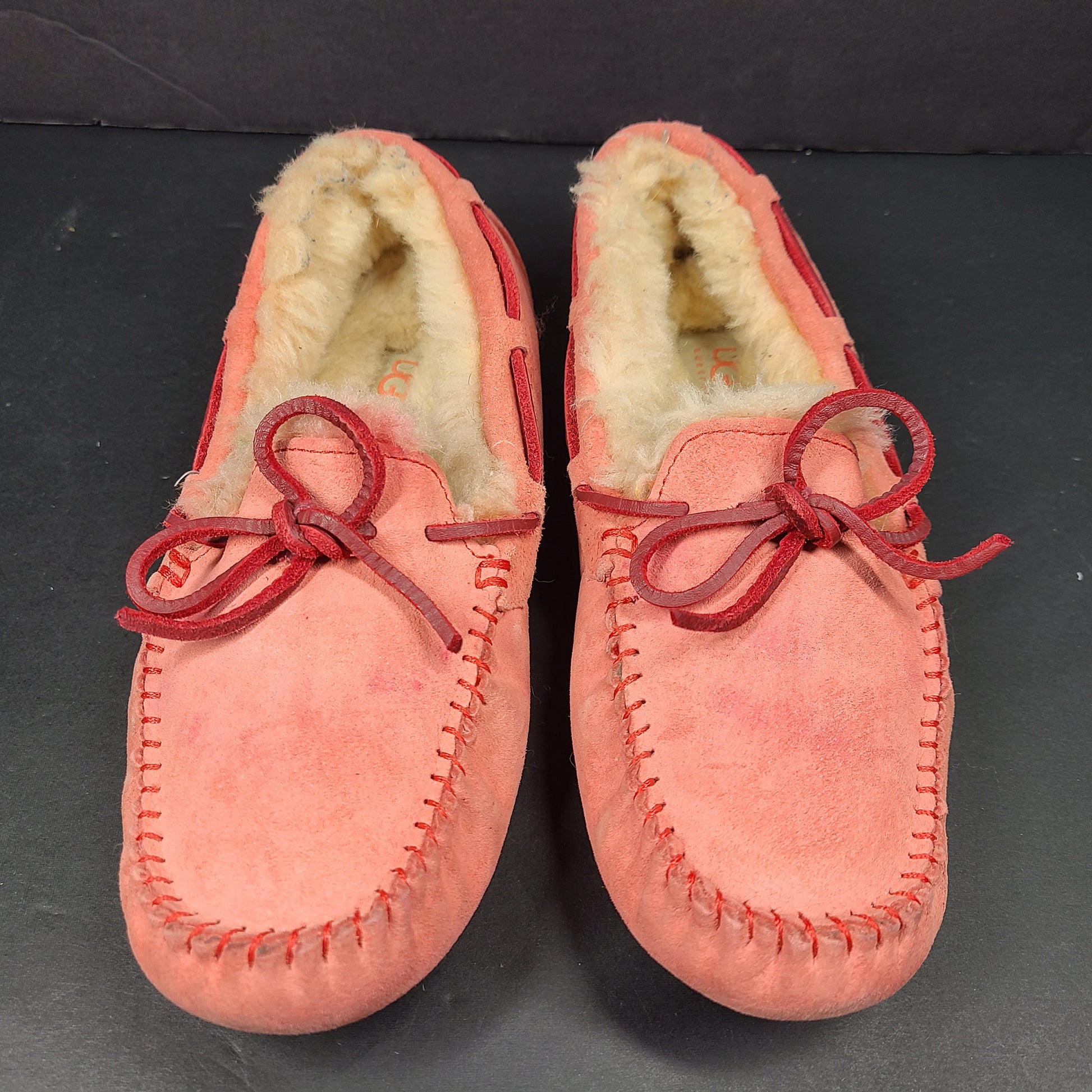 UGG Dakota moccasin slippers in pink suede for women's US 7 with soft lining and classic silhouette.