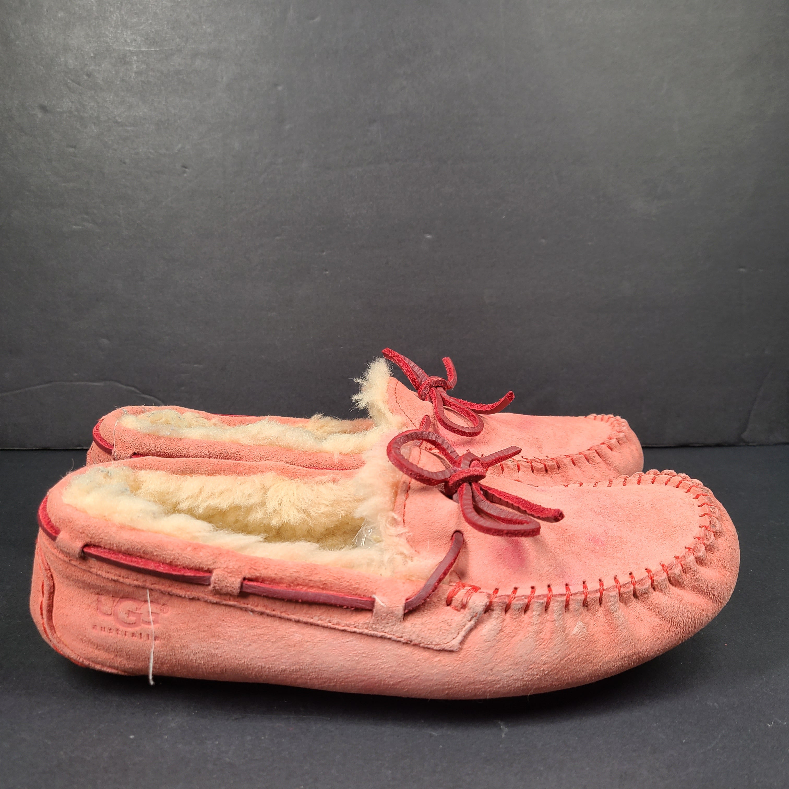 UGG Dakota moccasin slippers in pink suede for women's US 7 with soft lining and classic silhouette.