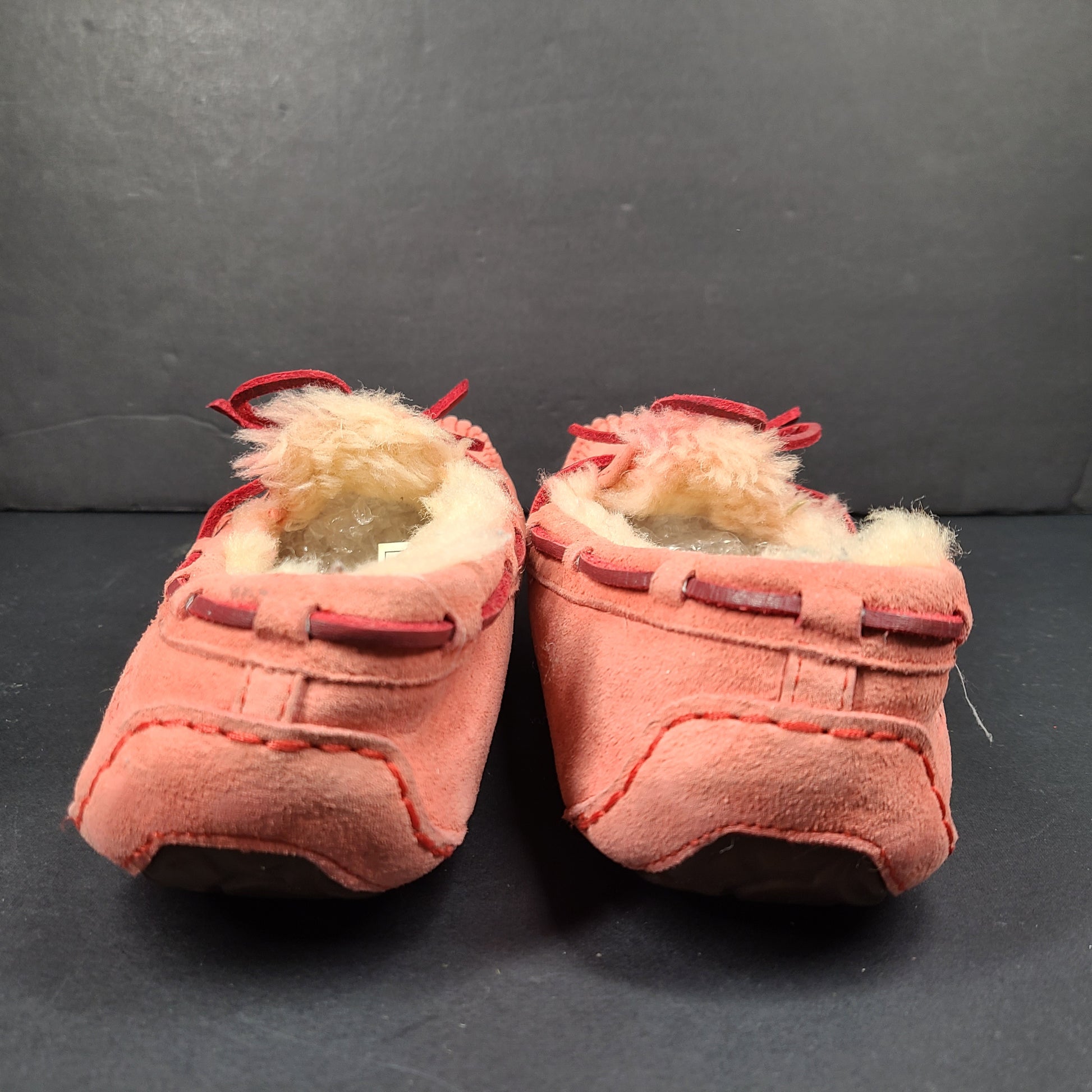 UGG Dakota moccasin slippers in pink suede for women's US 7 with soft lining and classic silhouette.