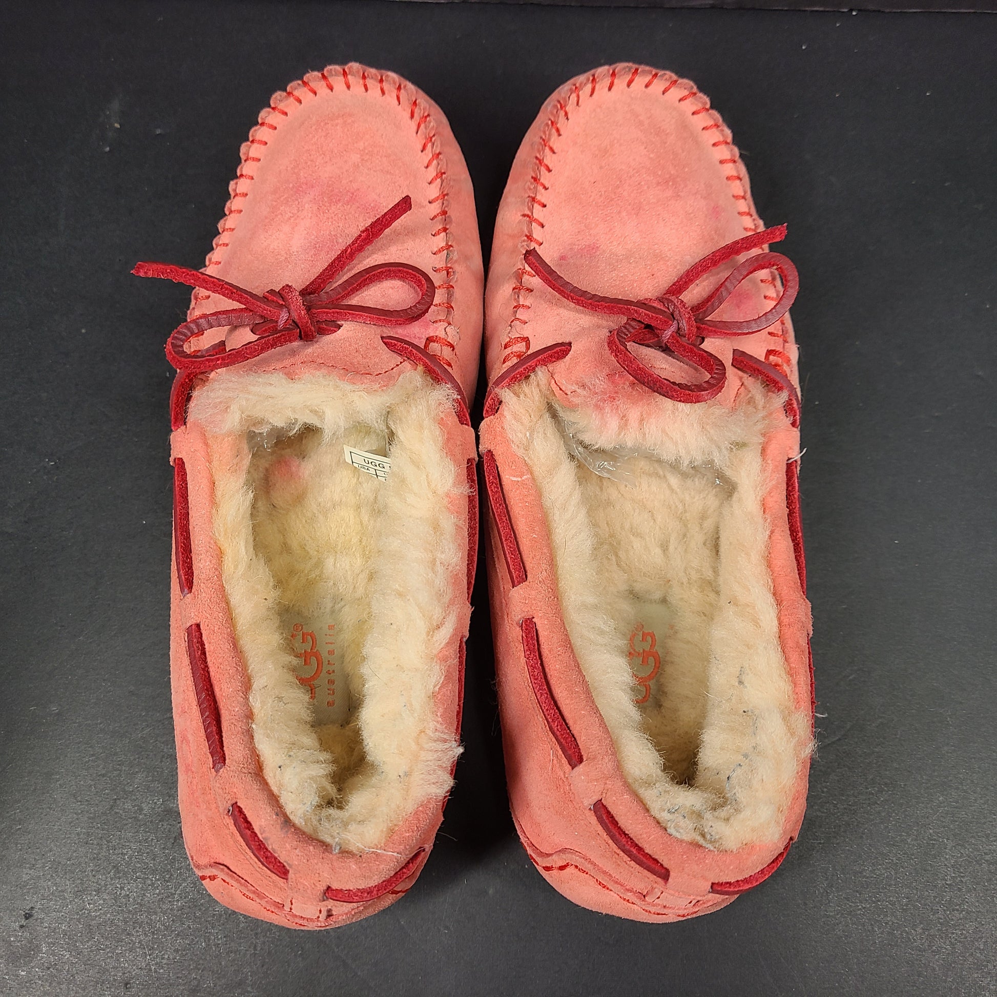 UGG Dakota moccasin slippers in pink suede for women's US 7 with soft lining and classic silhouette.