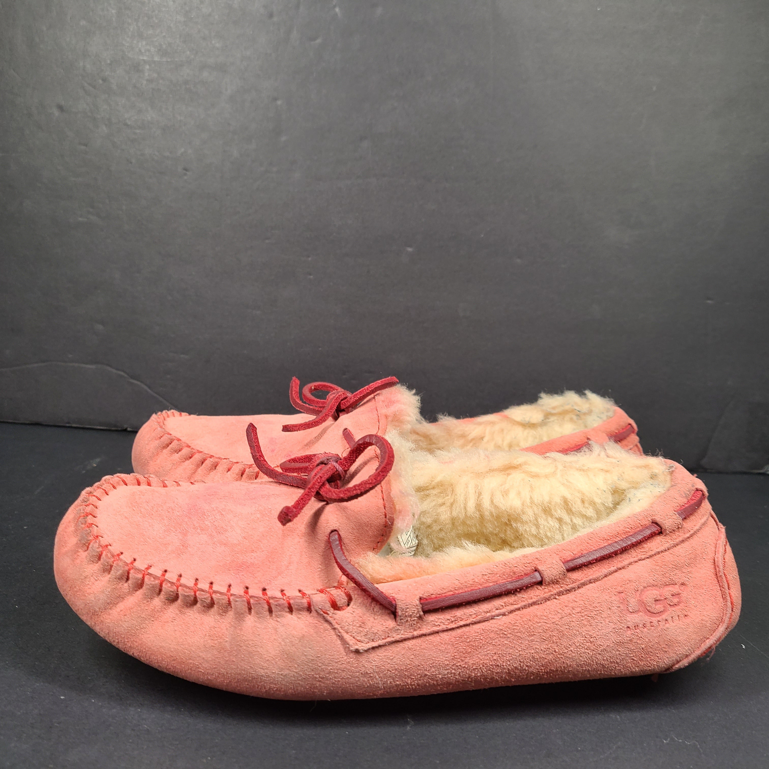 UGG Dakota moccasin slippers in pink suede for women's US 7 with soft lining and classic silhouette.