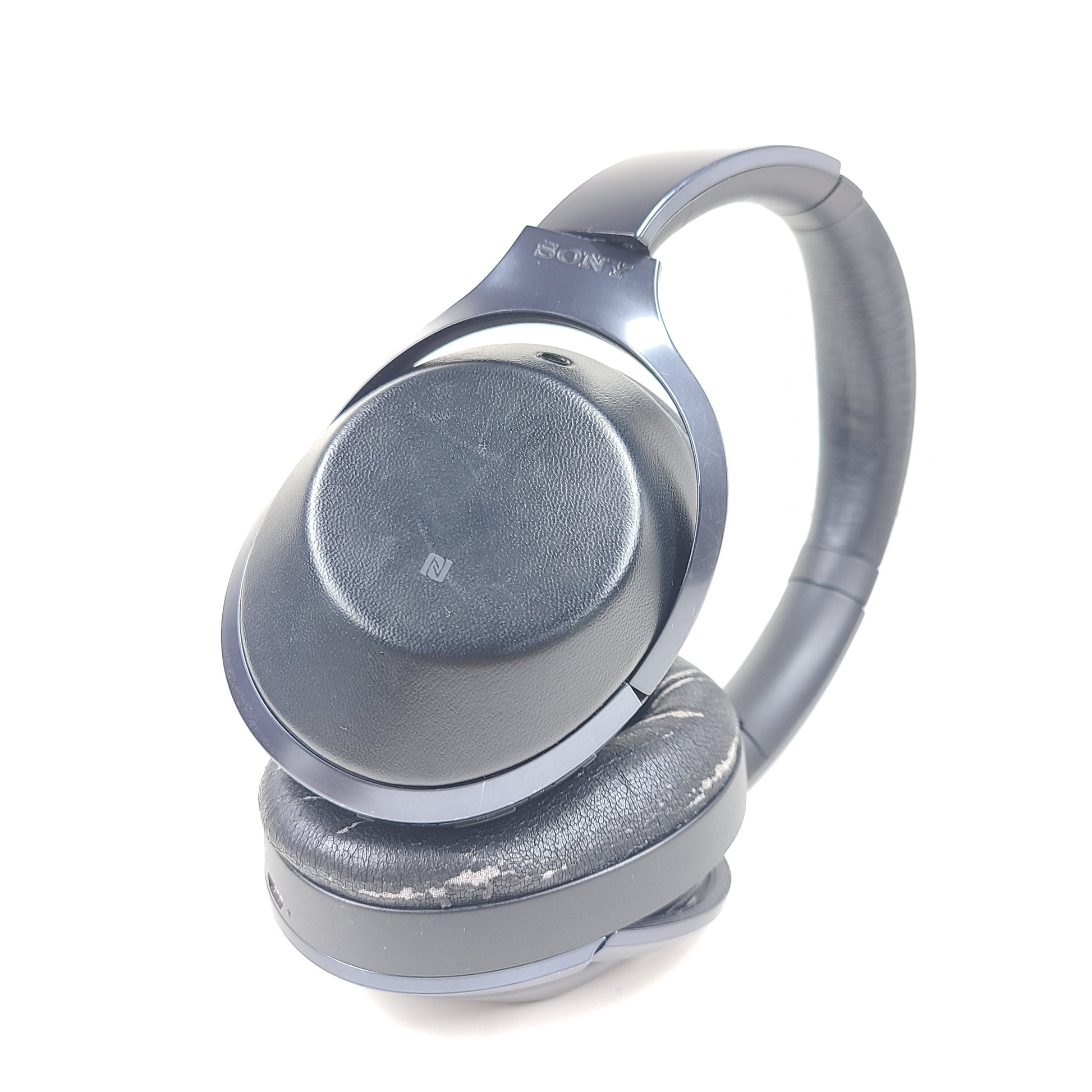 Over-ear Sony MDR-1000X headphones with active noise cancellation and a black finish.