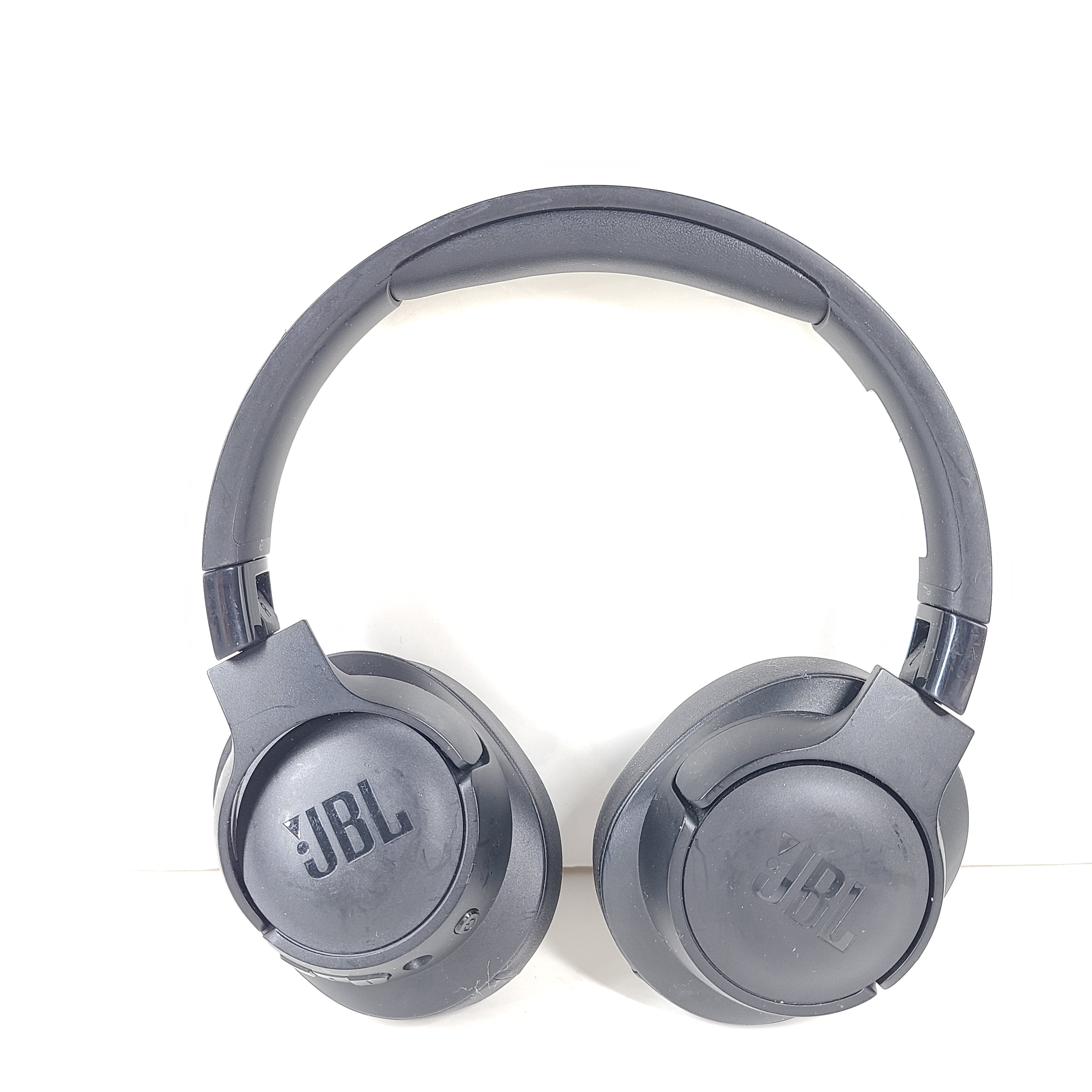 Over-ear JBL Tune 710BT wireless headphones in black with cushioned ear pads and adjustable headband for comfortable listening.