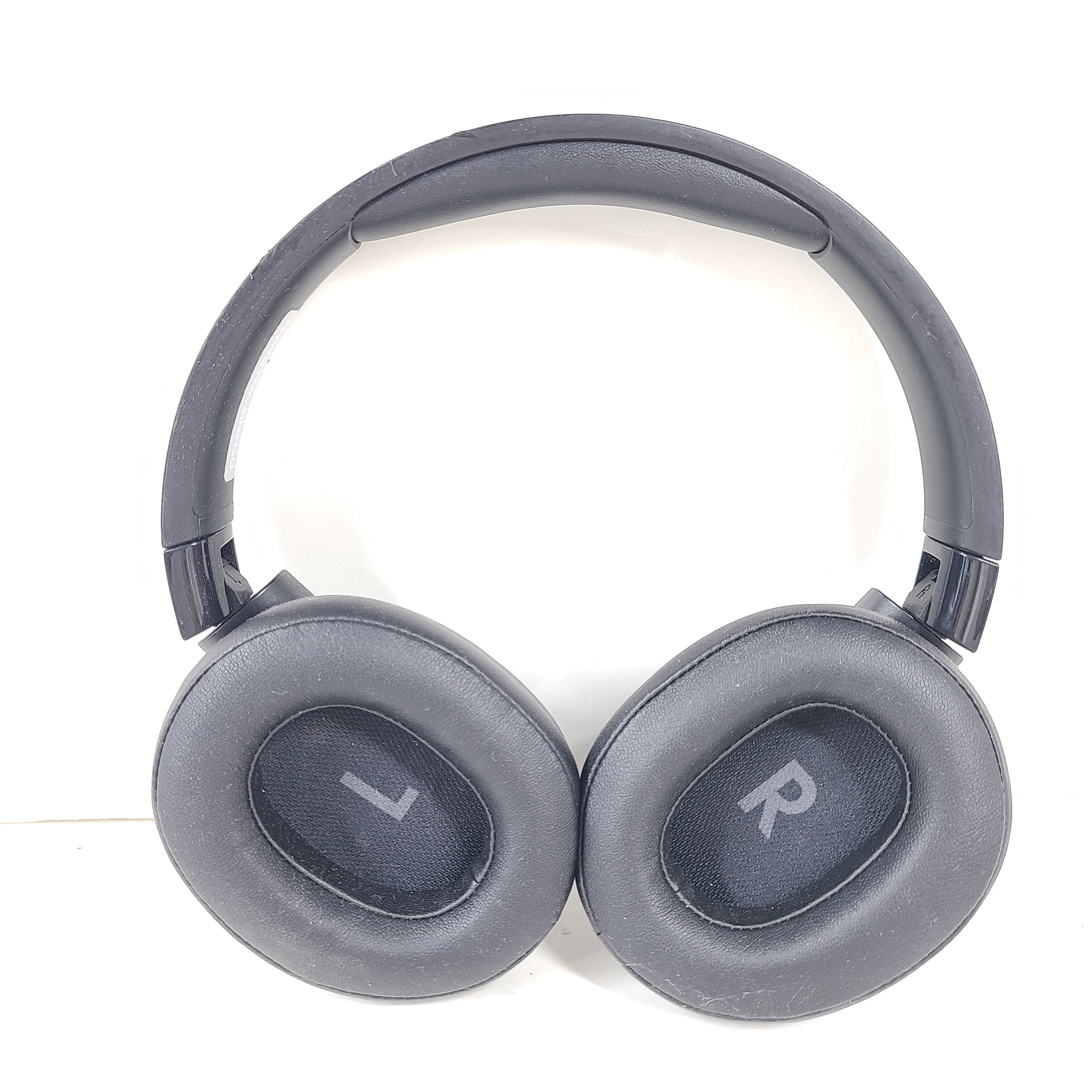 Over-ear JBL Tune 710BT wireless headphones in black with cushioned ear pads and adjustable headband for comfortable listening.