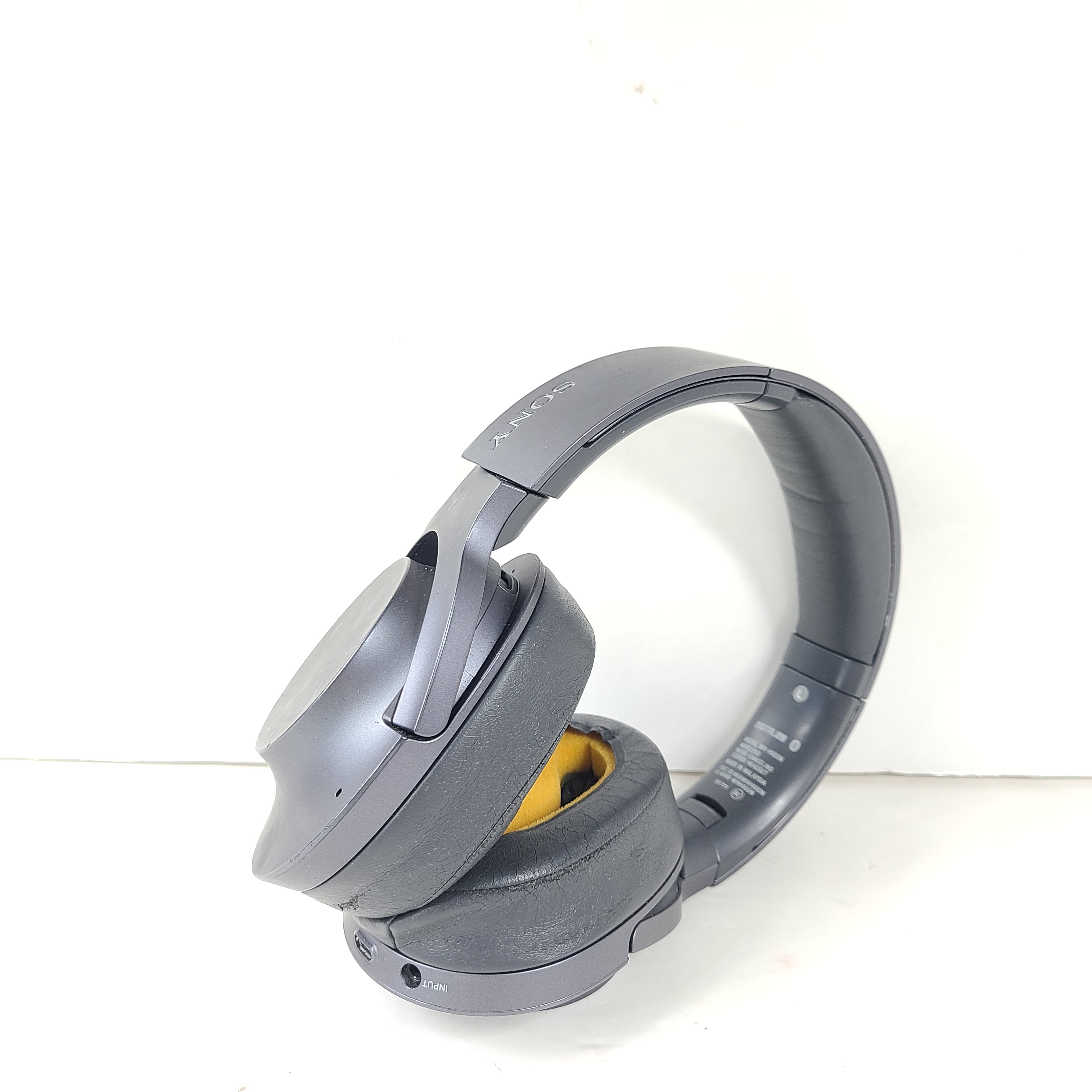 Over-ear Sony WH-H900N wireless headphones in gray with active noise cancellation and Bluetooth connectivity.