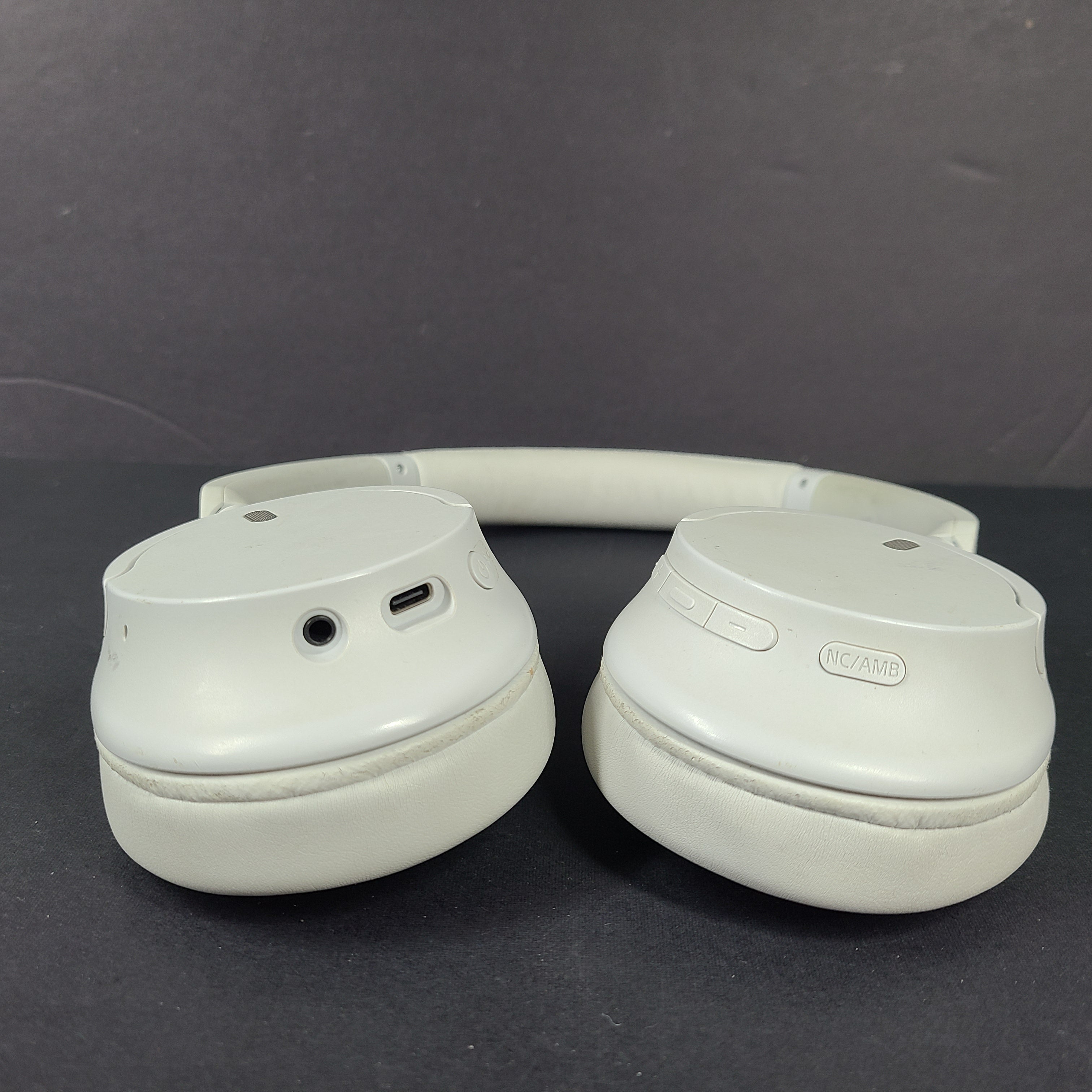 White Sony WH-CH720N over-ear noise-cancelling headphones with adjustable headband and control buttons.