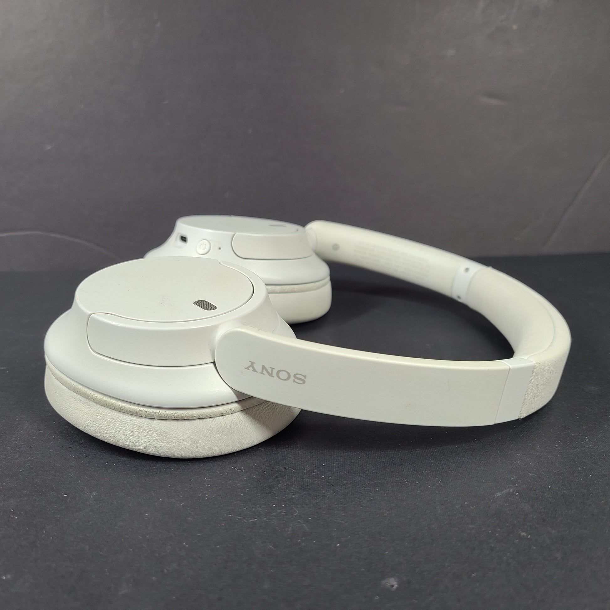 White Sony WH-CH720N over-ear noise-cancelling headphones with adjustable headband and control buttons.