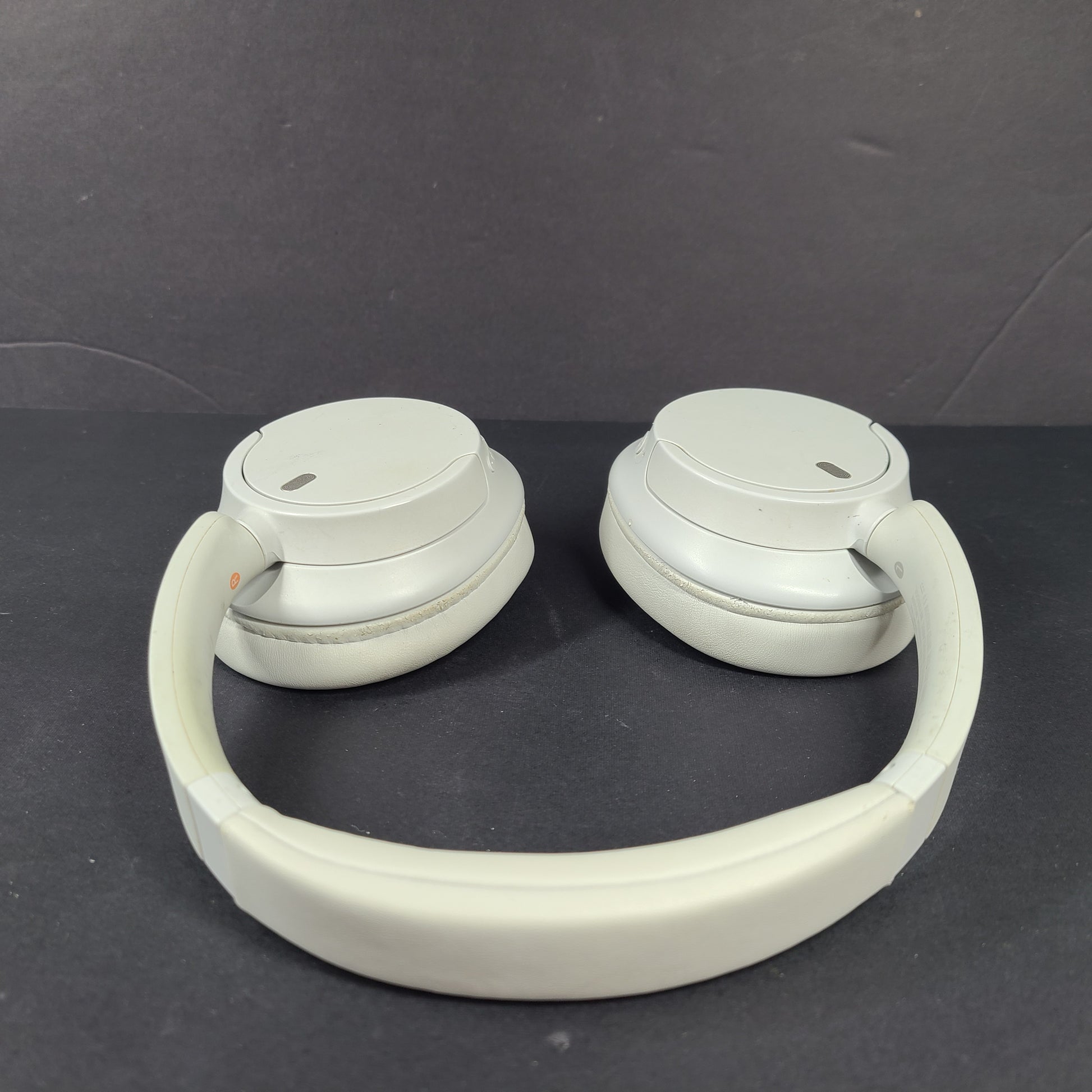 White Sony WH-CH720N over-ear noise-cancelling headphones with adjustable headband and control buttons.