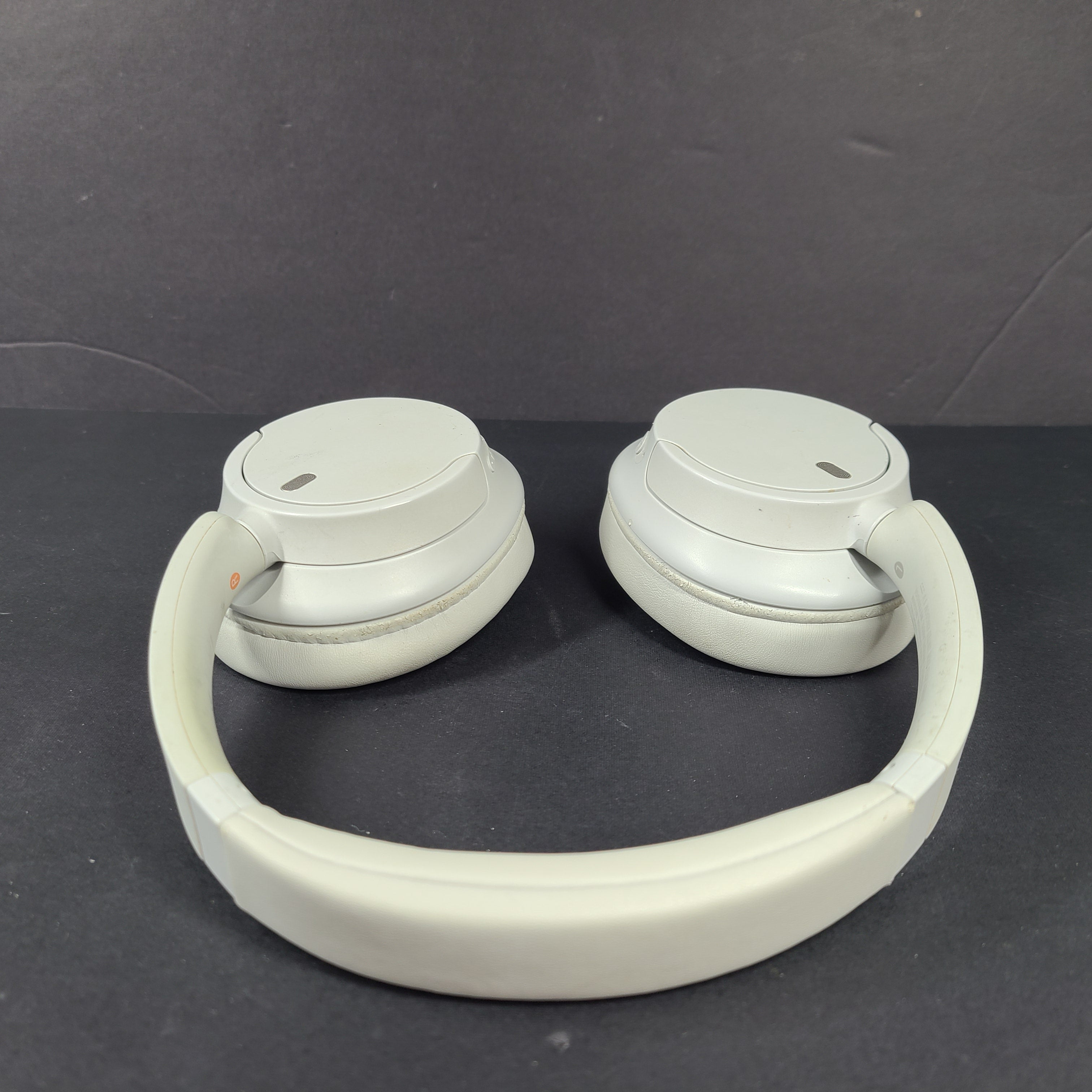 White Sony WH-CH720N over-ear noise-cancelling headphones with adjustable headband and control buttons.