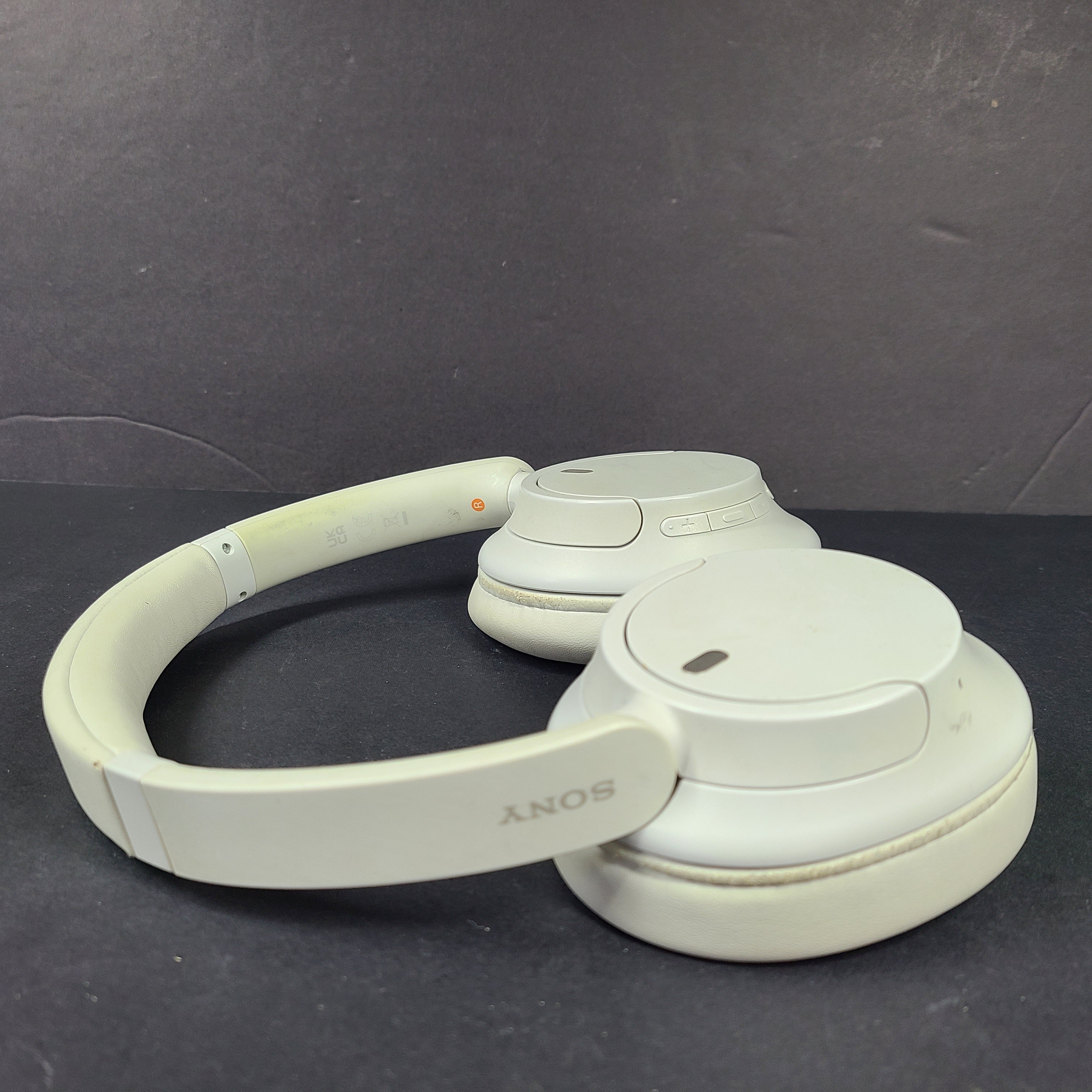 White Sony WH-CH720N over-ear noise-cancelling headphones with adjustable headband and control buttons.