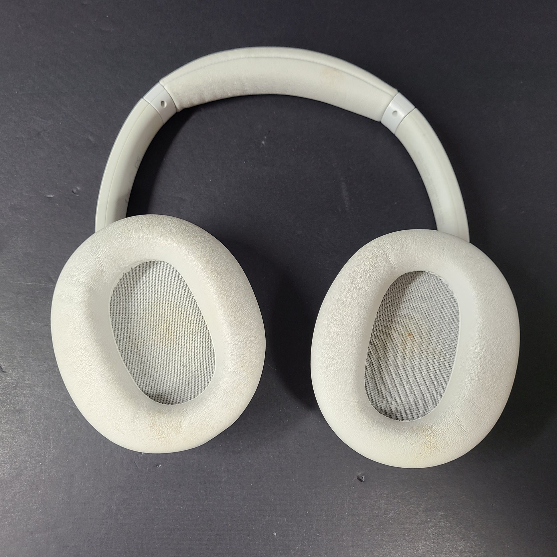 White Sony WH-CH720N over-ear noise-cancelling headphones with adjustable headband and control buttons.