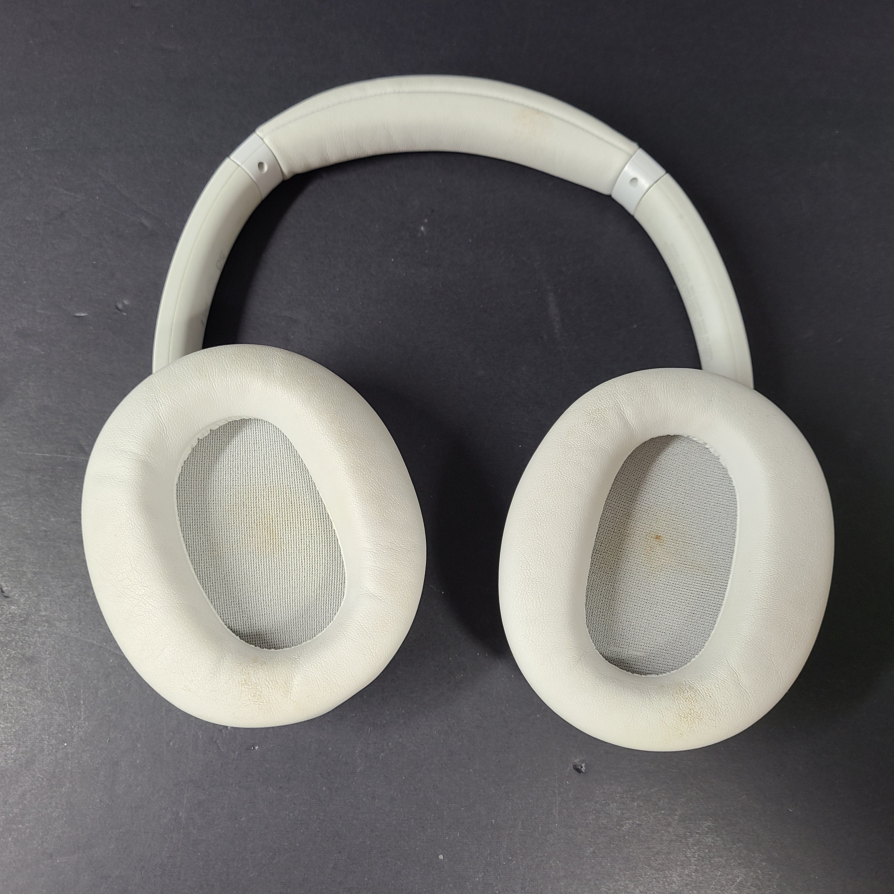 White Sony WH-CH720N over-ear noise-cancelling headphones with adjustable headband and control buttons.