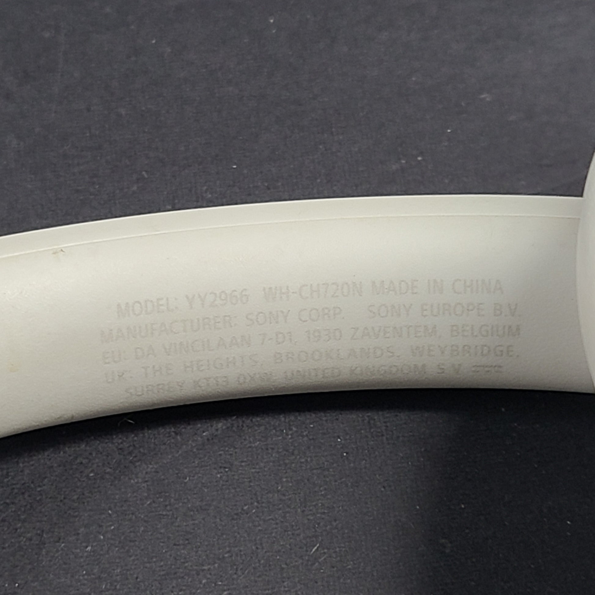 White Sony WH-CH720N over-ear noise-cancelling headphones with adjustable headband and control buttons.