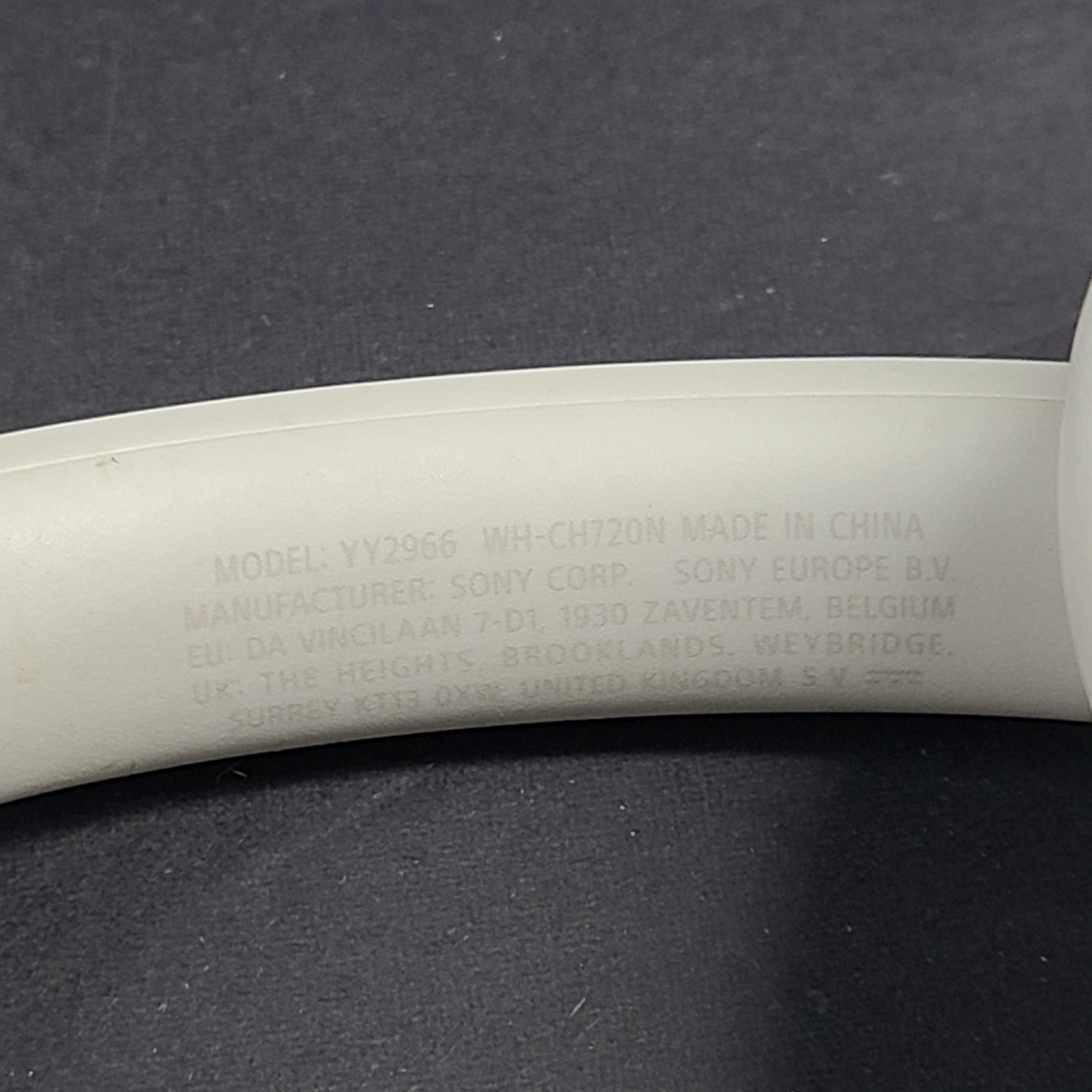 White Sony WH-CH720N over-ear noise-cancelling headphones with adjustable headband and control buttons.