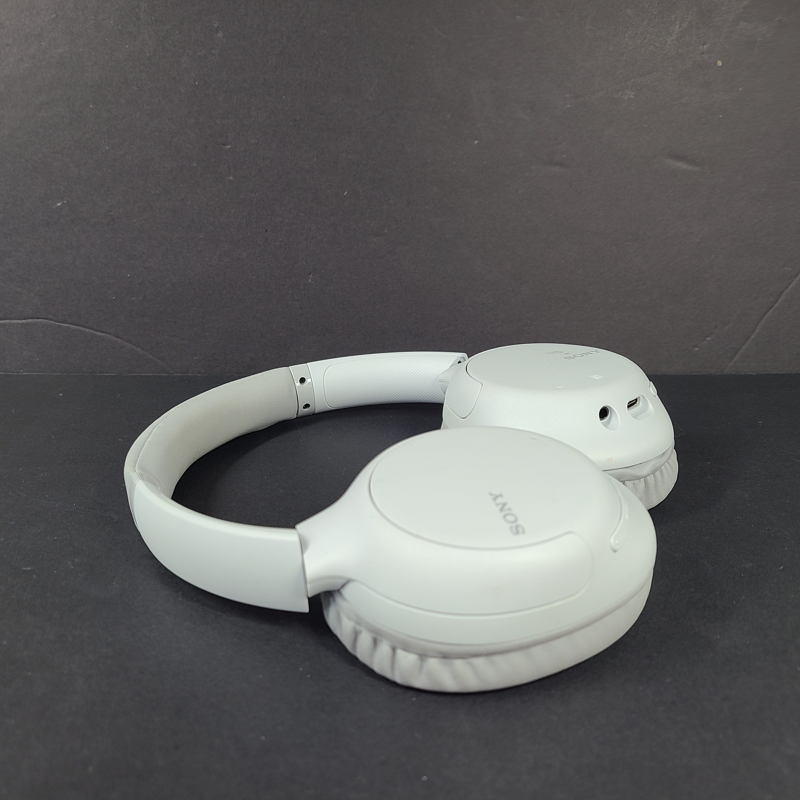 Sony WH-CH710N wireless over-ear headphones in gray with active noise cancellation and cushioned earcups.