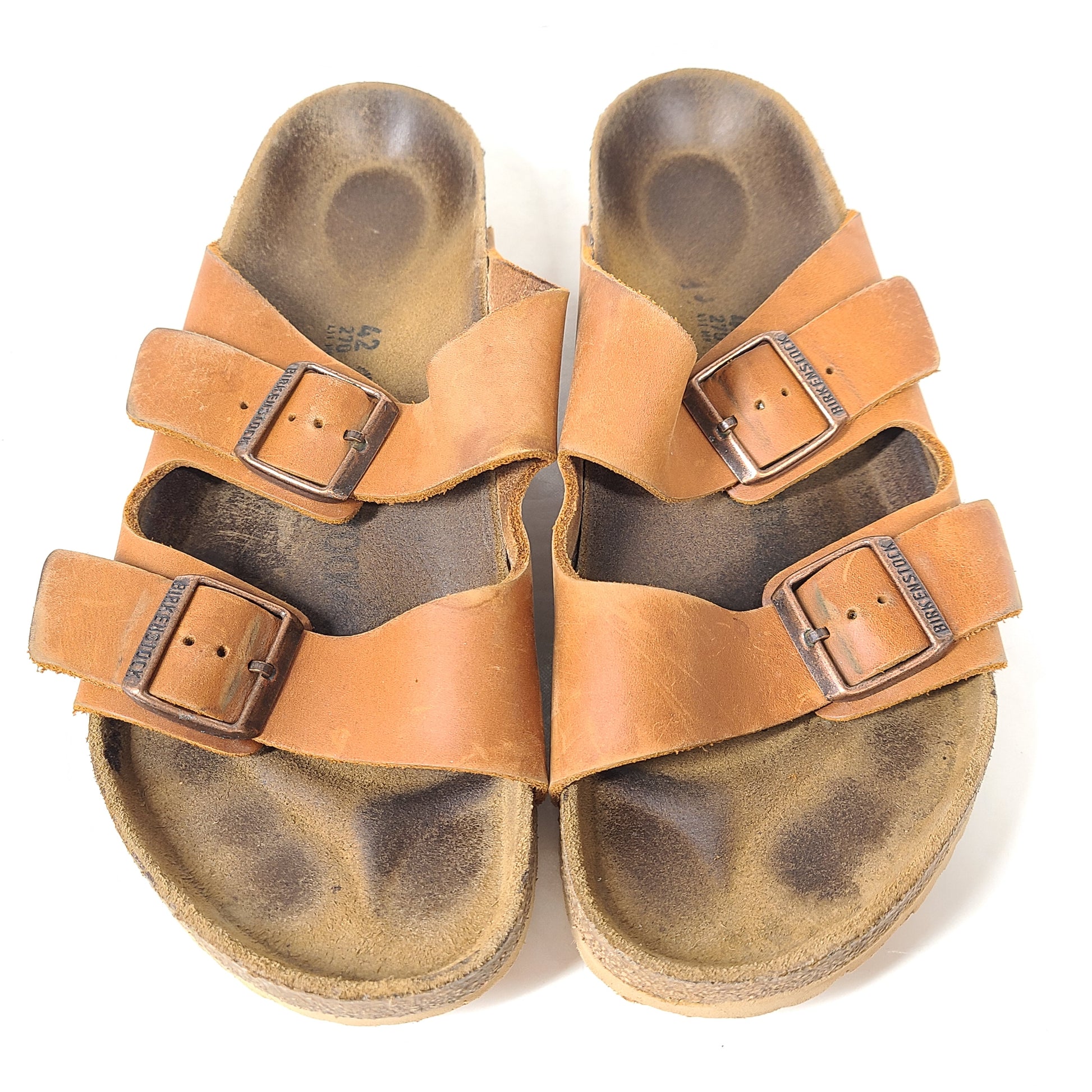 Brown Birkenstock sandals in EU size 42, model 278 with an imprint on the footbed and mild wear on straps and footbeds.
