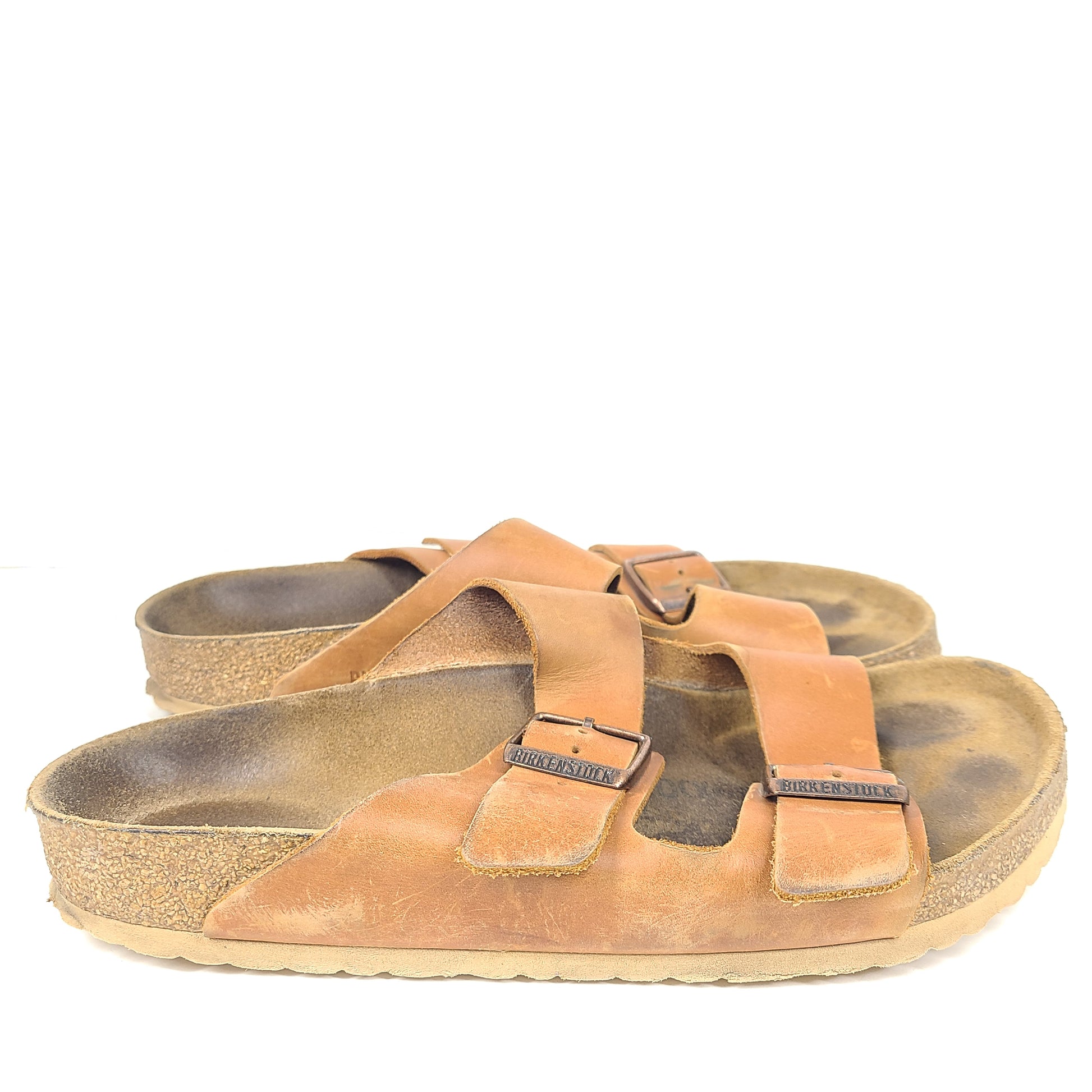 Brown Birkenstock sandals in EU size 42, model 278 with an imprint on the footbed and mild wear on straps and footbeds.