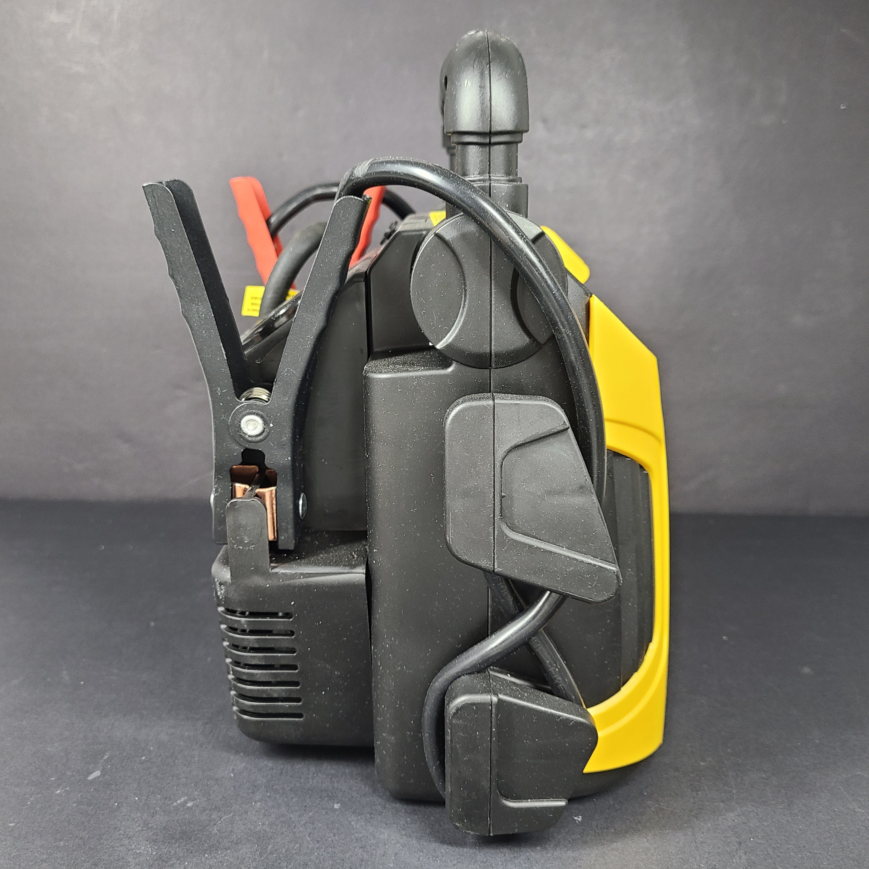 Yellow and black EverStart Maxx jump starter with built-in jumper cables and an integrated air compressor for portable vehicle power and inflation.