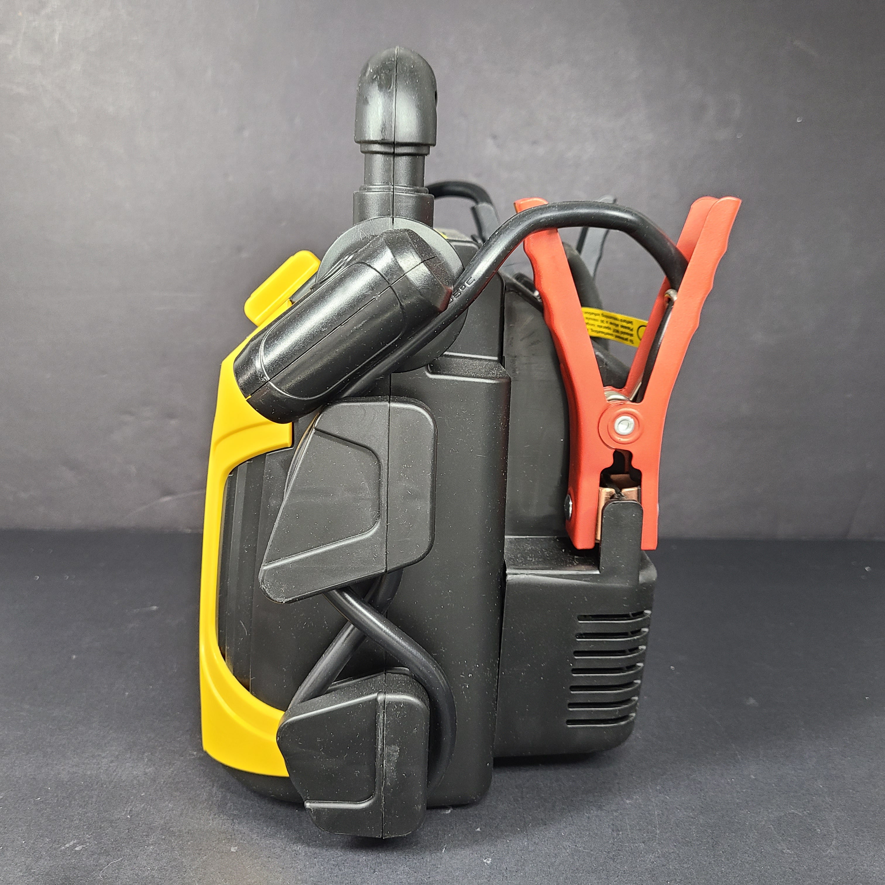 Yellow and black EverStart Maxx jump starter with built-in jumper cables and an integrated air compressor for portable vehicle power and inflation.