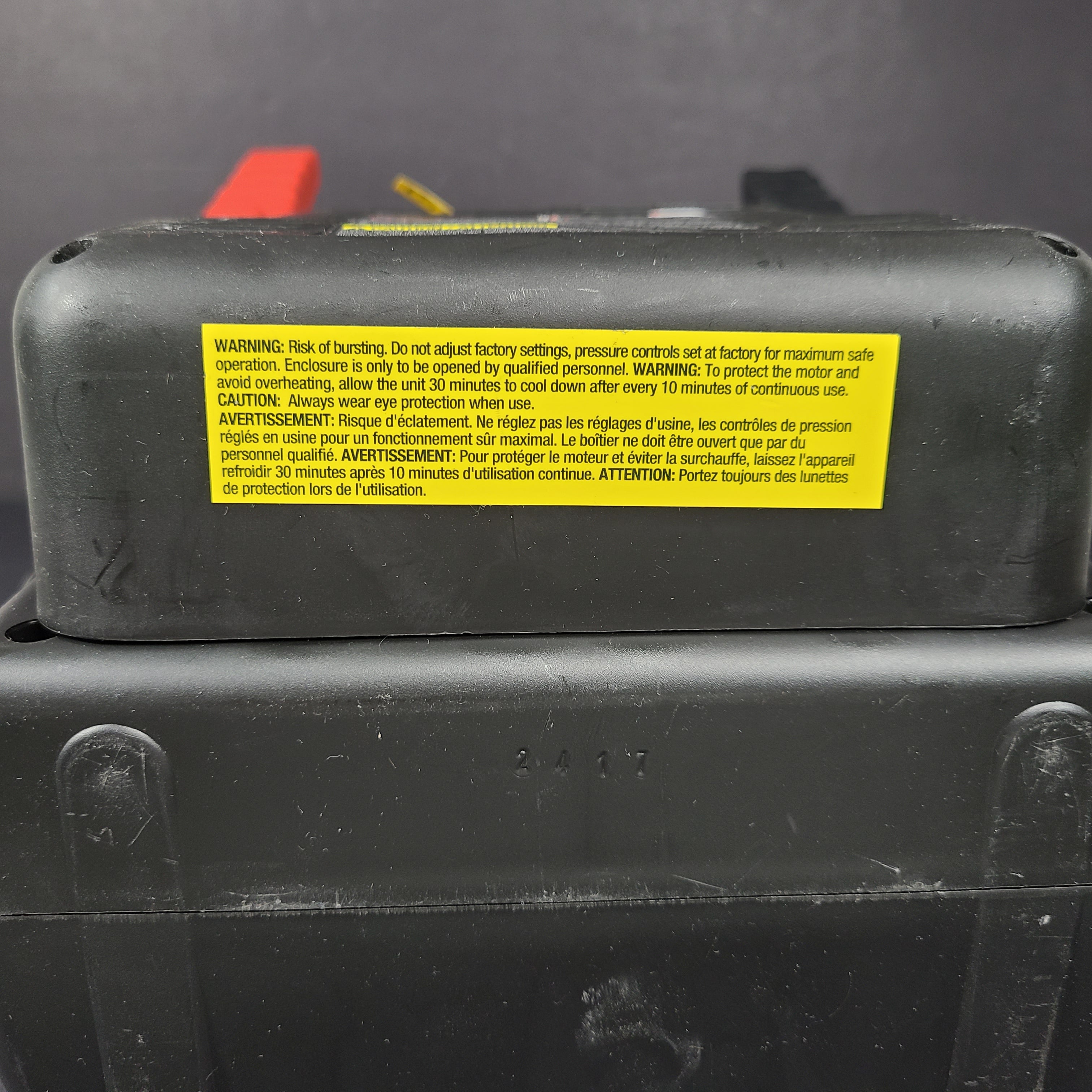 Yellow and black EverStart Maxx jump starter with built-in jumper cables and an integrated air compressor for portable vehicle power and inflation.