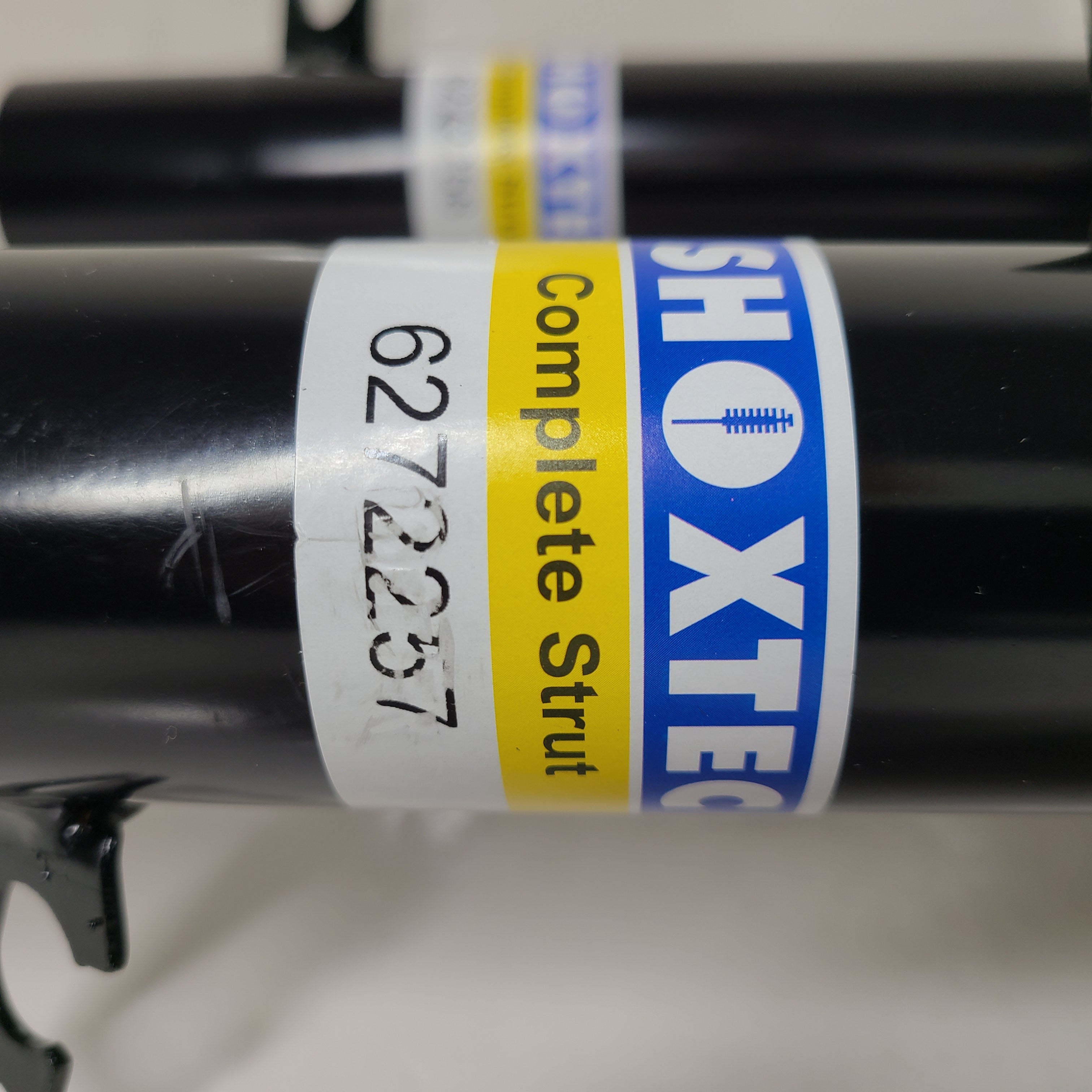 Two Shoxtec Complete Struts in black with mounting accessories for vehicle suspension replacement.