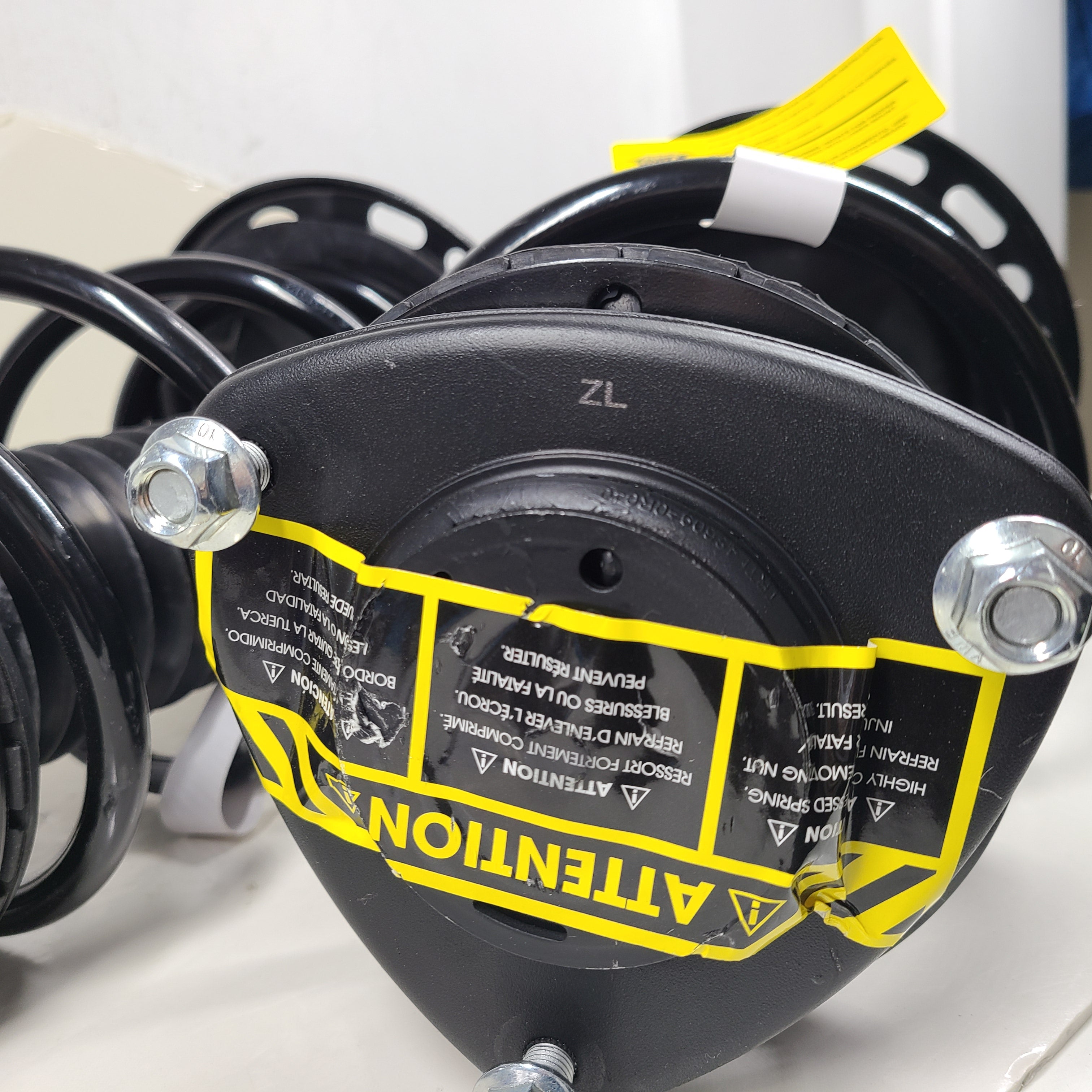 Unity black suspension strut assembly for models 123LL246 and 124CL245, intended for vehicle suspension replacement.
