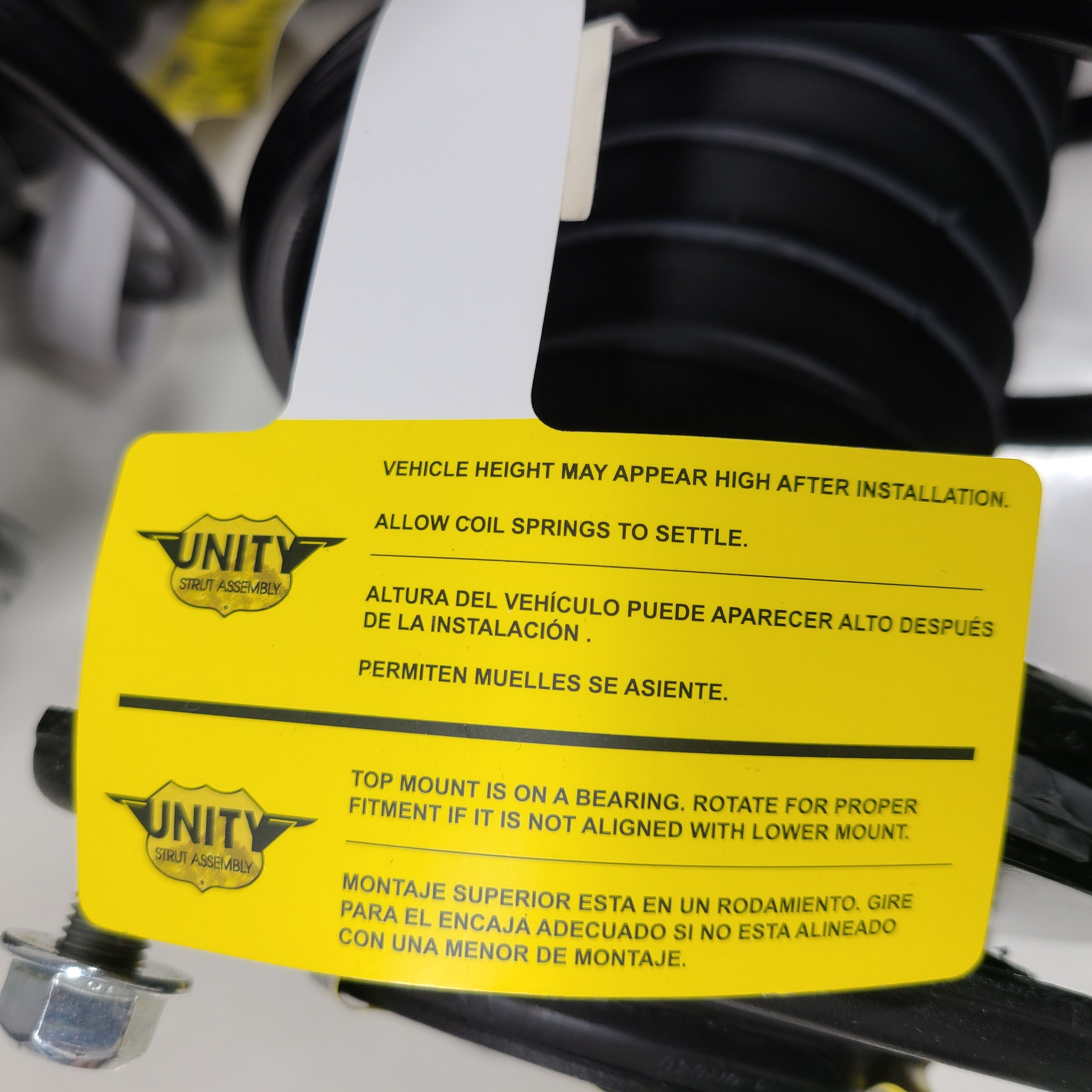 Unity black suspension strut assembly for models 123LL246 and 124CL245, intended for vehicle suspension replacement.