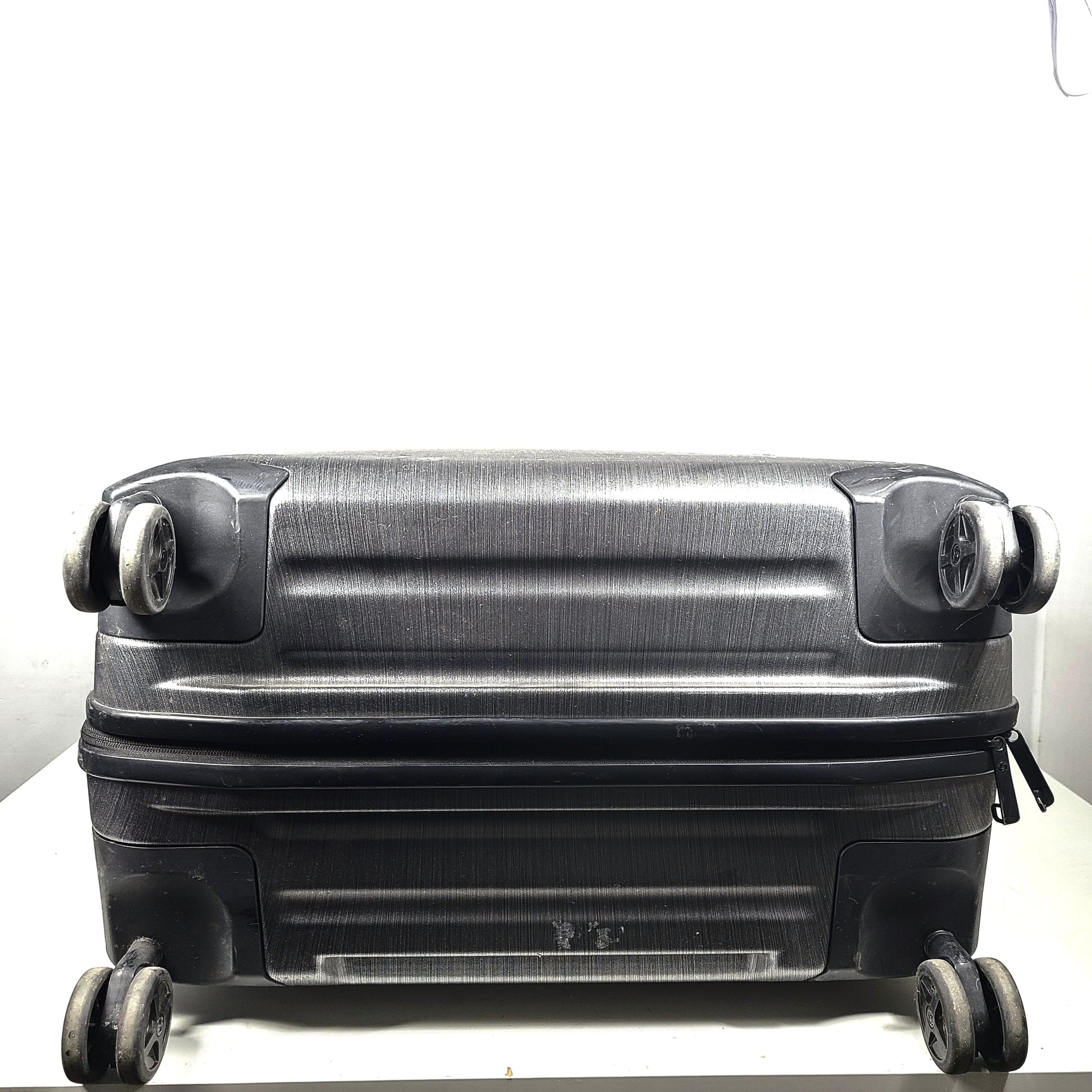 Black Samsonite Spinner 81/30 suitcase with scuffing on wheels and a clean interior.