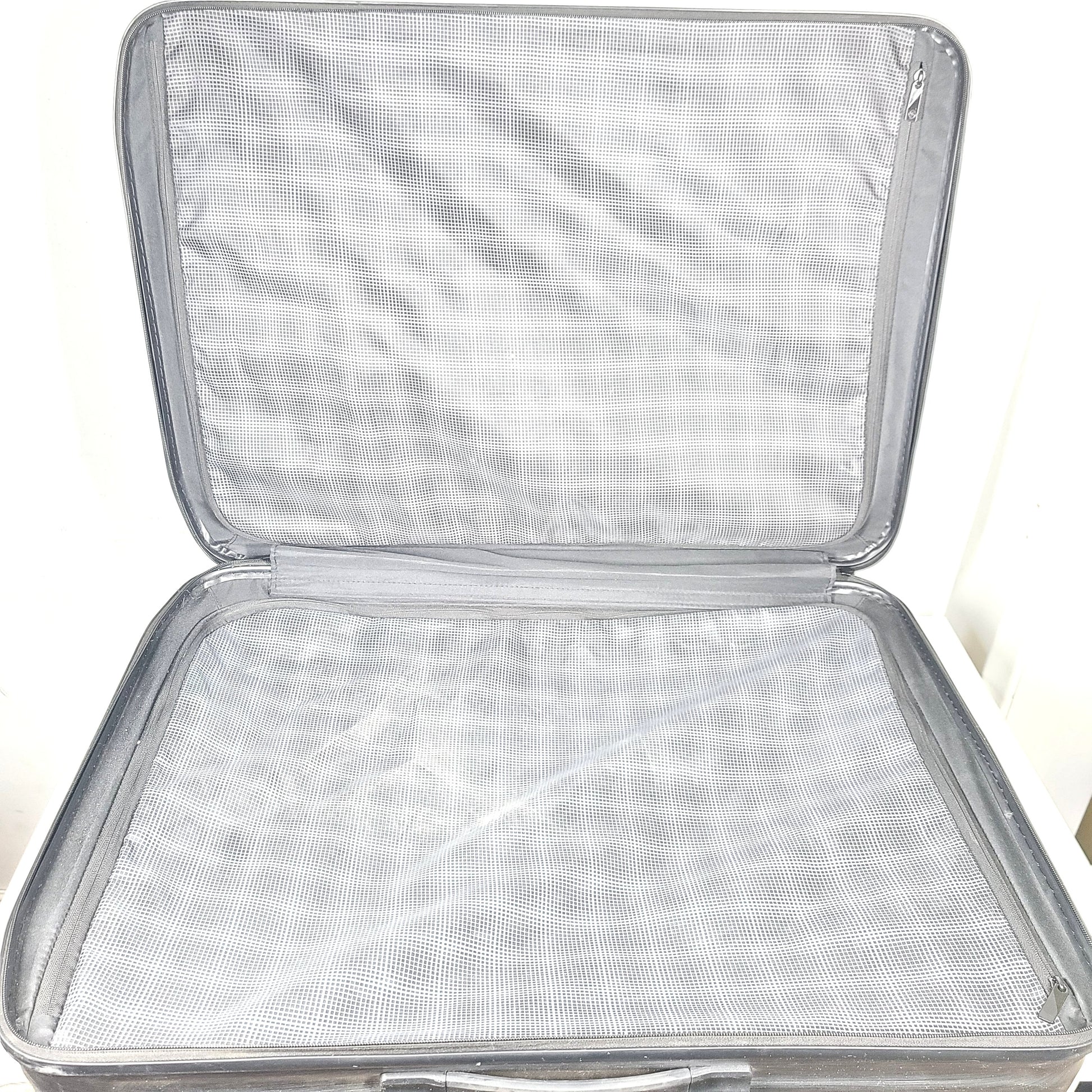 Black Samsonite Spinner 81/30 suitcase with scuffing on wheels and a clean interior.