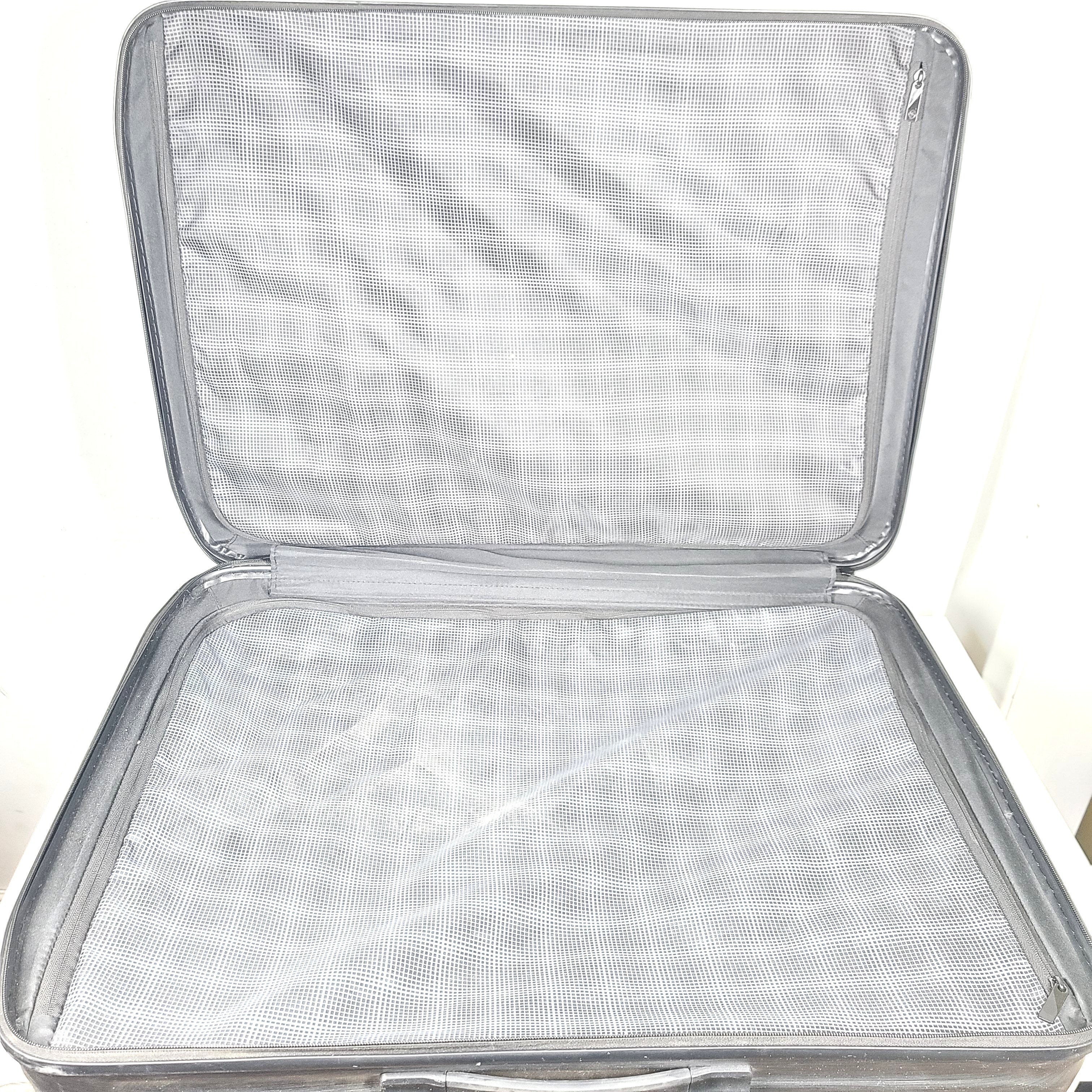 Black Samsonite Spinner 81/30 suitcase with scuffing on wheels and a clean interior.