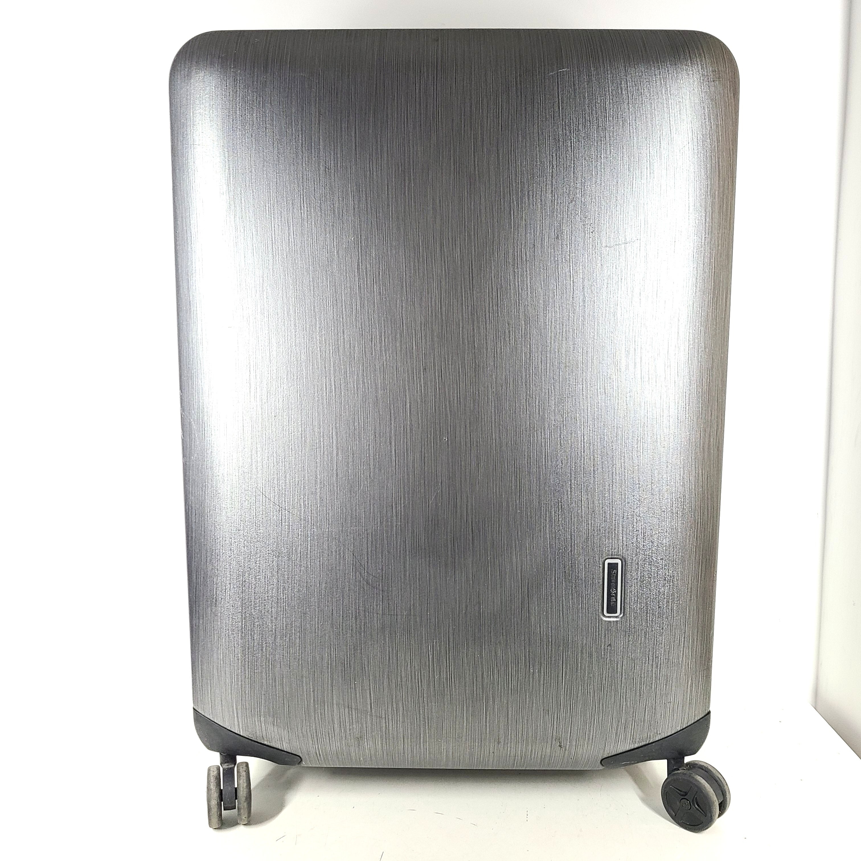 Black Samsonite Spinner 81/30 suitcase with scuffing on wheels and a clean interior.