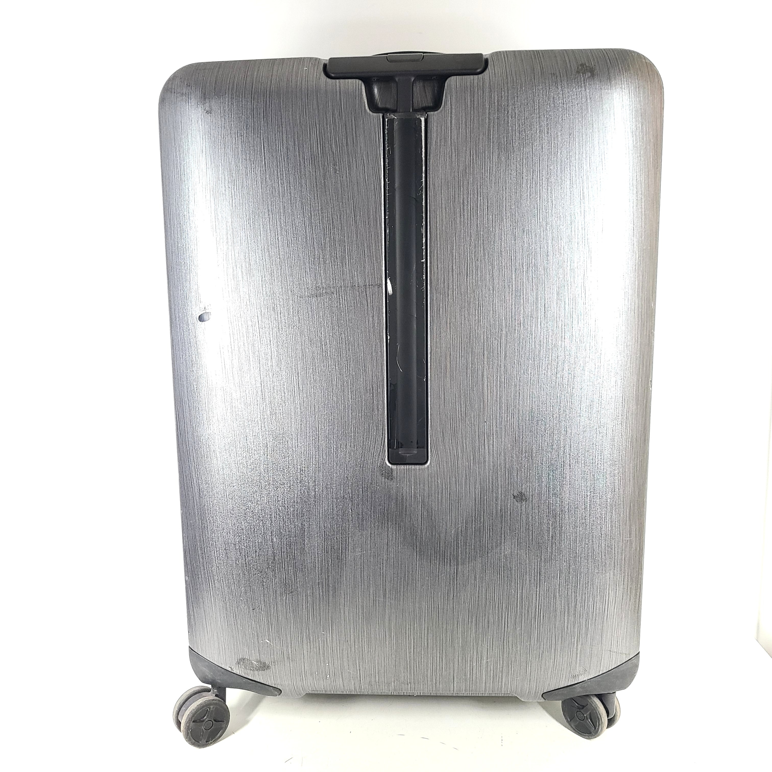 Black Samsonite Spinner 81/30 suitcase with scuffing on wheels and a clean interior.