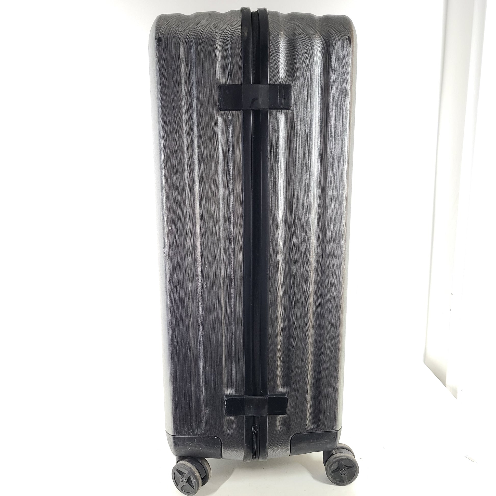 Black Samsonite Spinner 81/30 suitcase with scuffing on wheels and a clean interior.