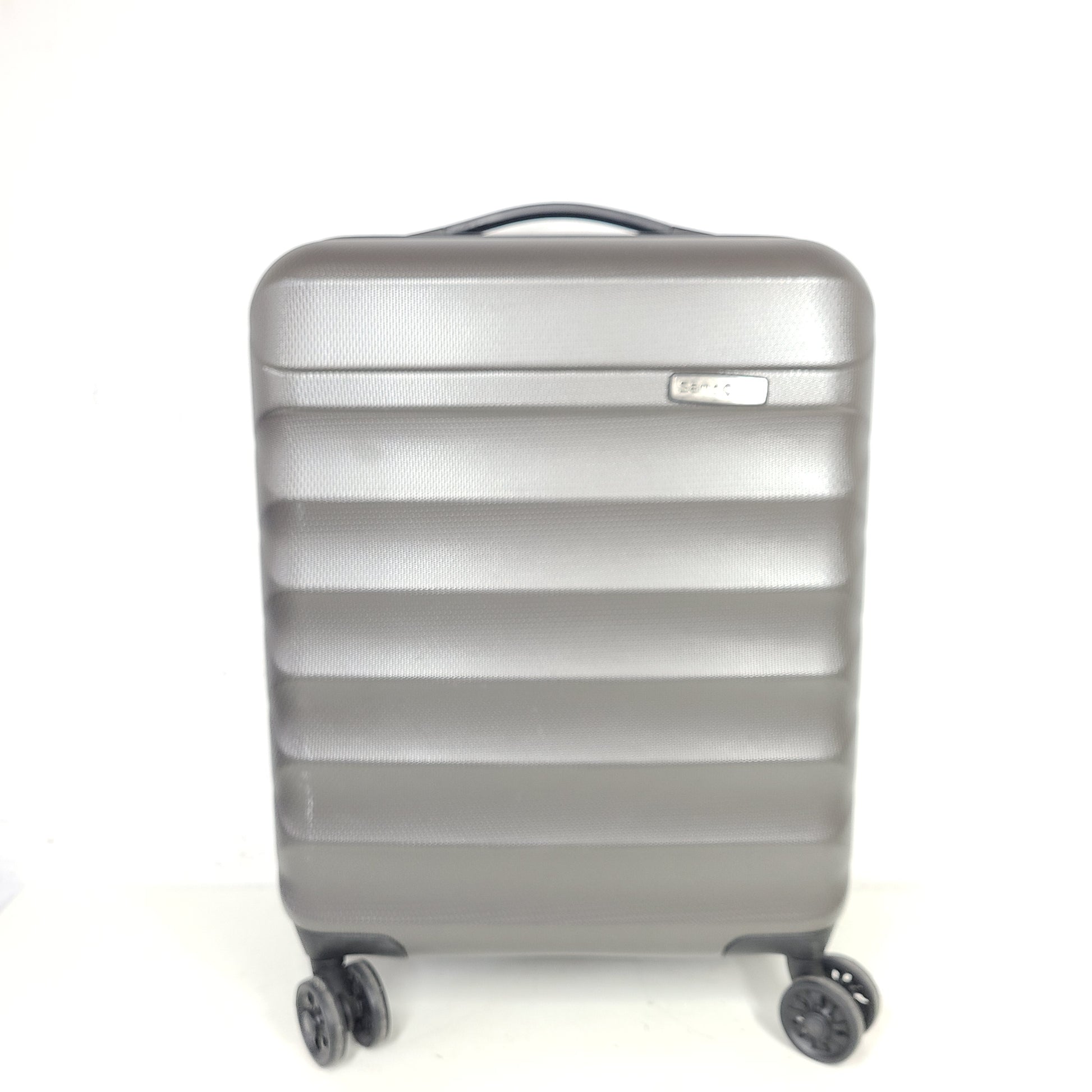 Gray ESPACE carry-on luggage constructed from polyethylene vinyl acetate with scuffs and an intact interior.