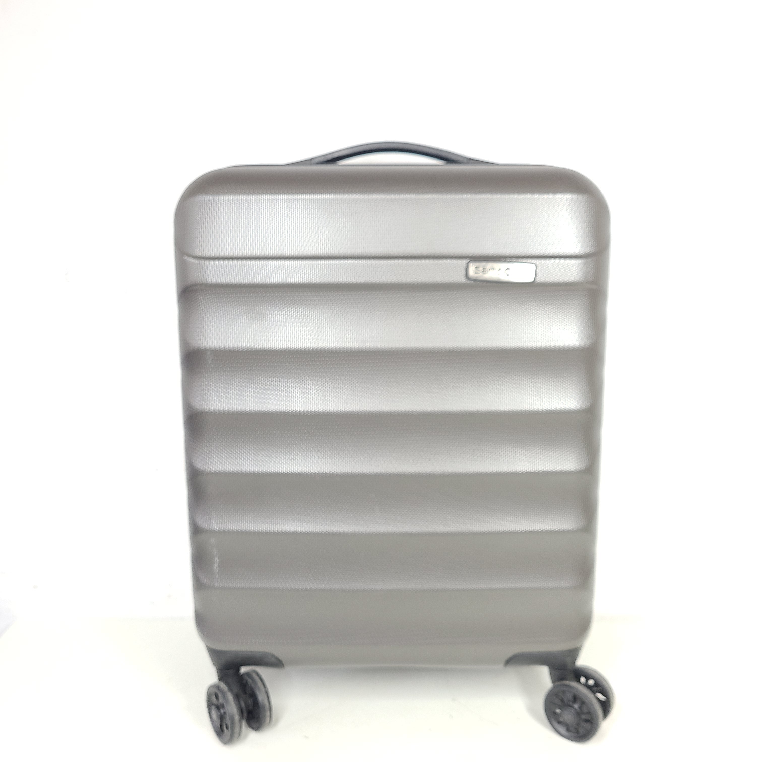 Gray ESPACE carry-on luggage constructed from polyethylene vinyl acetate with scuffs and an intact interior.