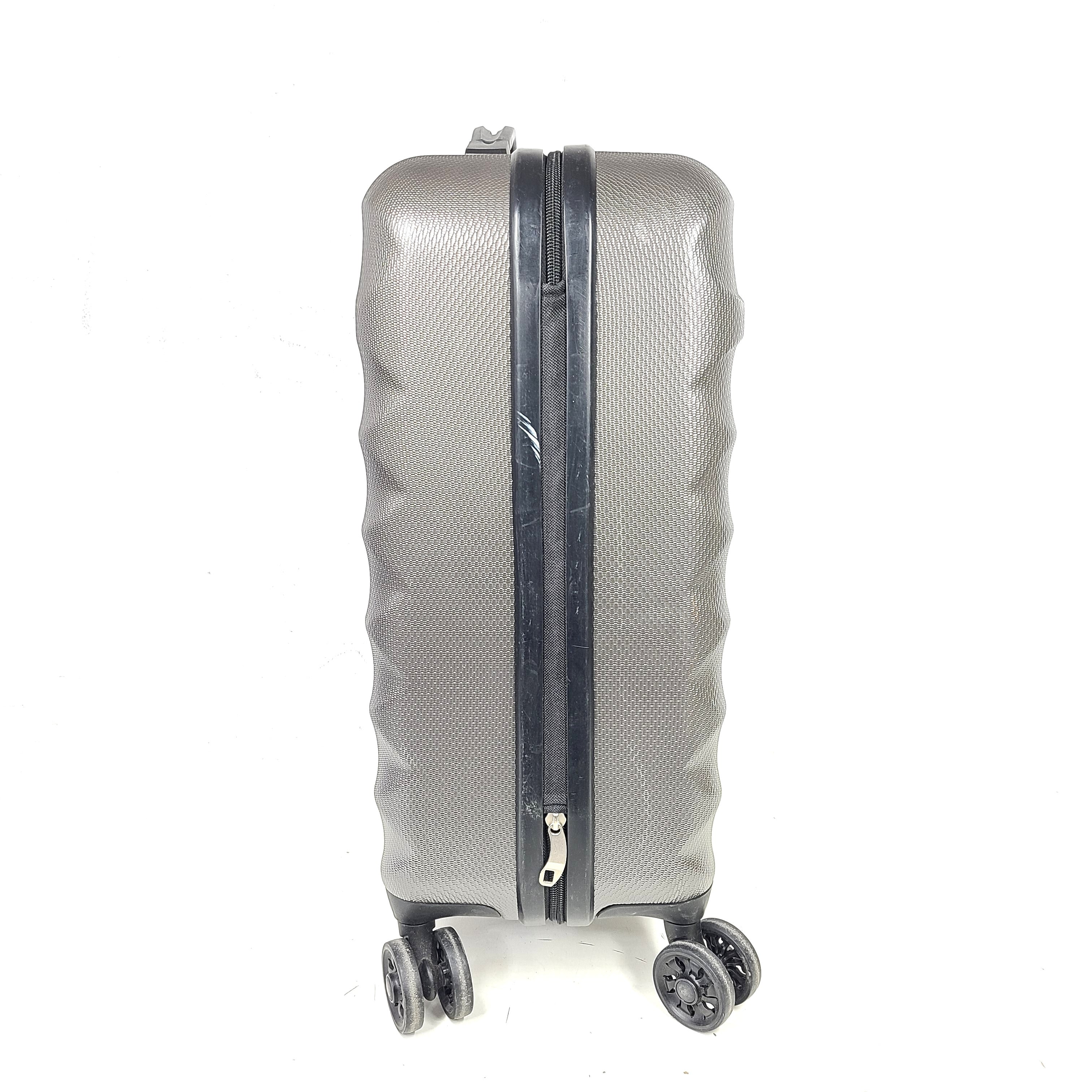 Gray ESPACE carry-on luggage constructed from polyethylene vinyl acetate with scuffs and an intact interior.