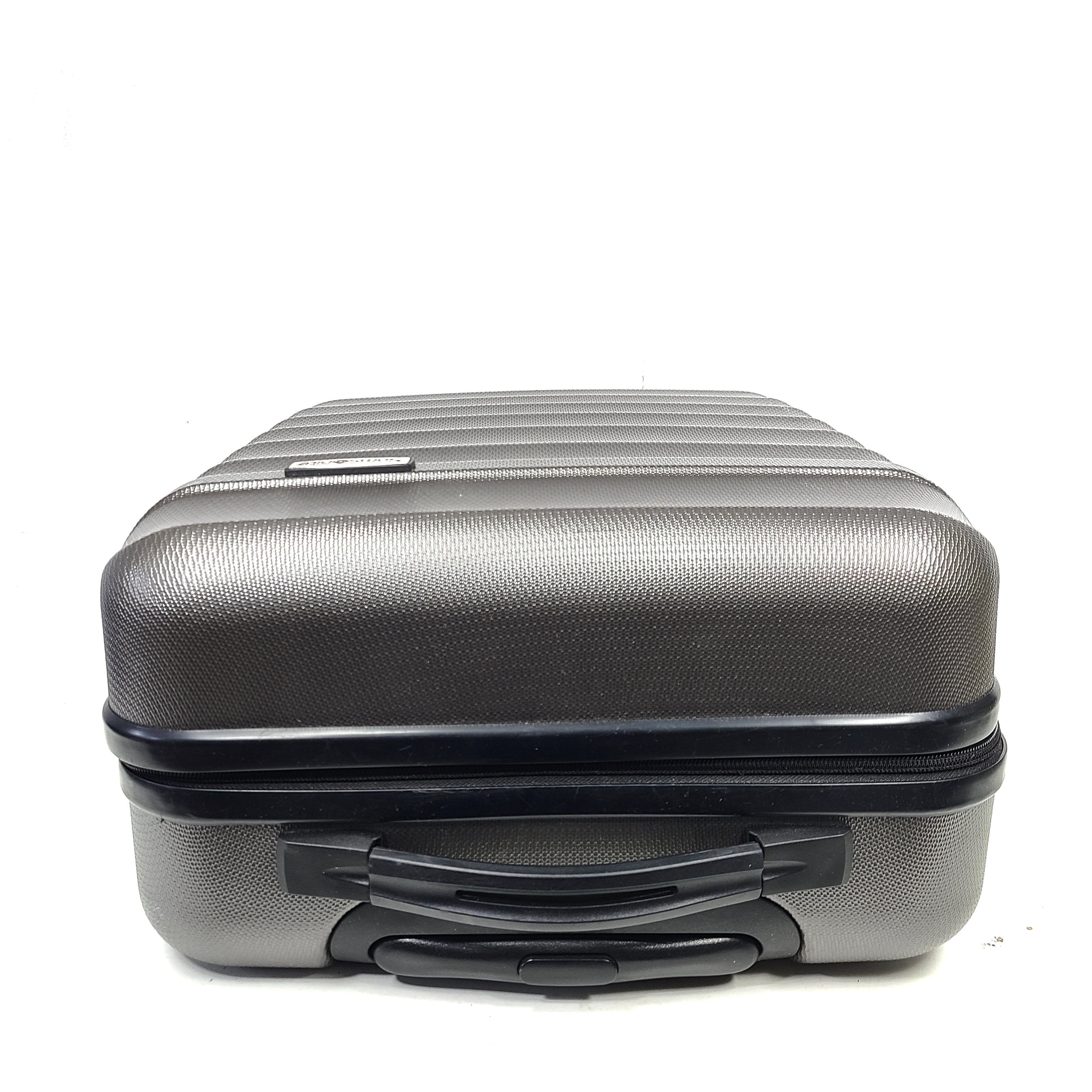 Gray ESPACE carry-on luggage constructed from polyethylene vinyl acetate with scuffs and an intact interior.