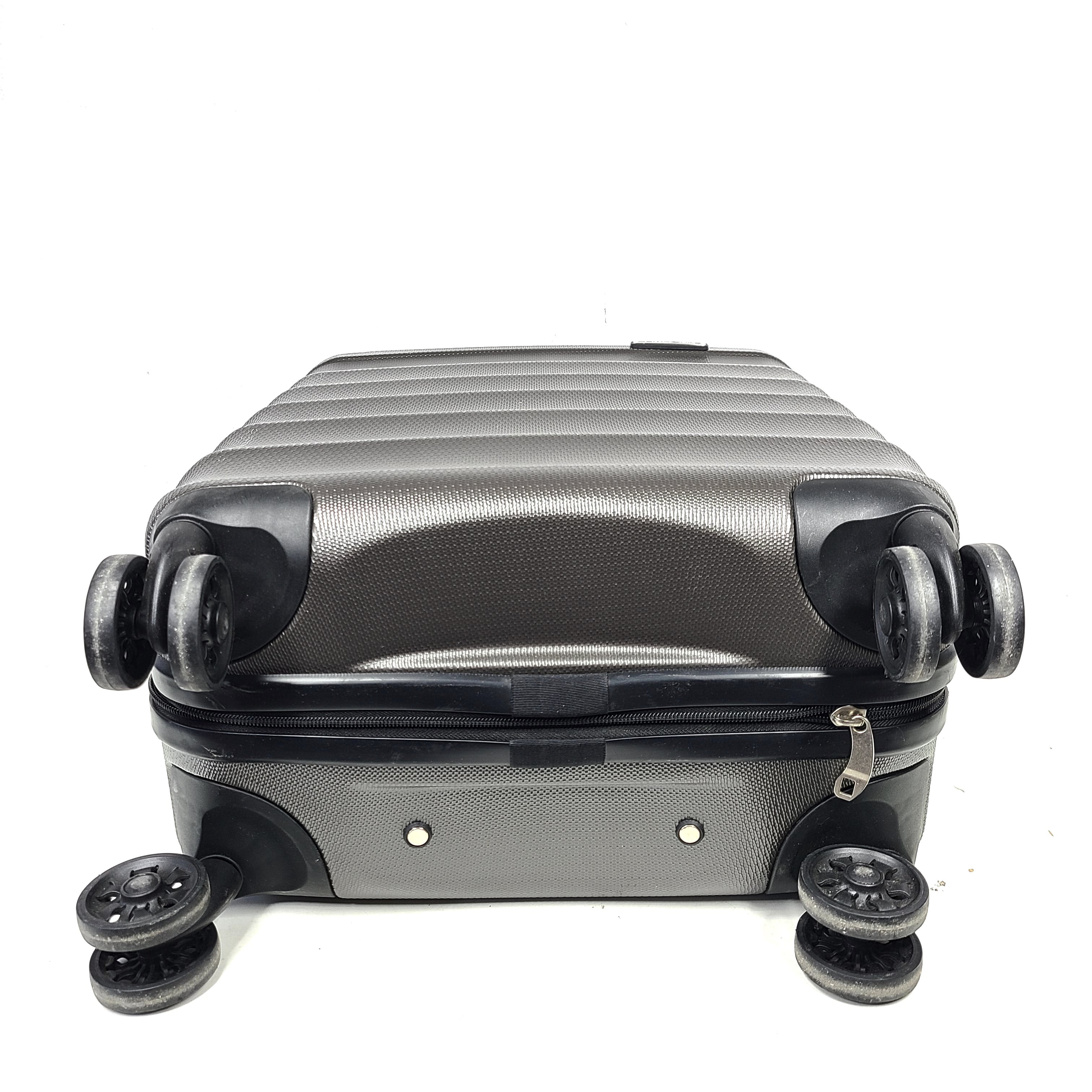 Gray ESPACE carry-on luggage constructed from polyethylene vinyl acetate with scuffs and an intact interior.