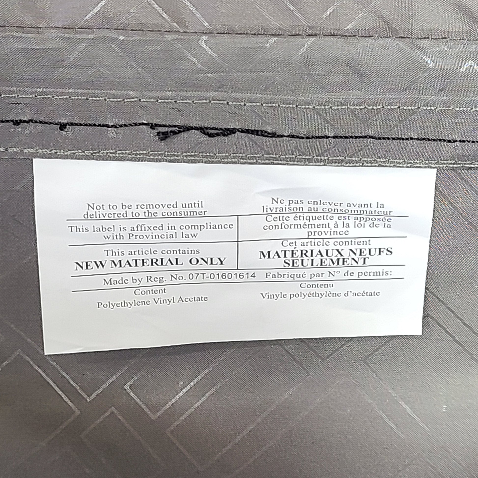 Gray ESPACE carry-on luggage constructed from polyethylene vinyl acetate with scuffs and an intact interior.