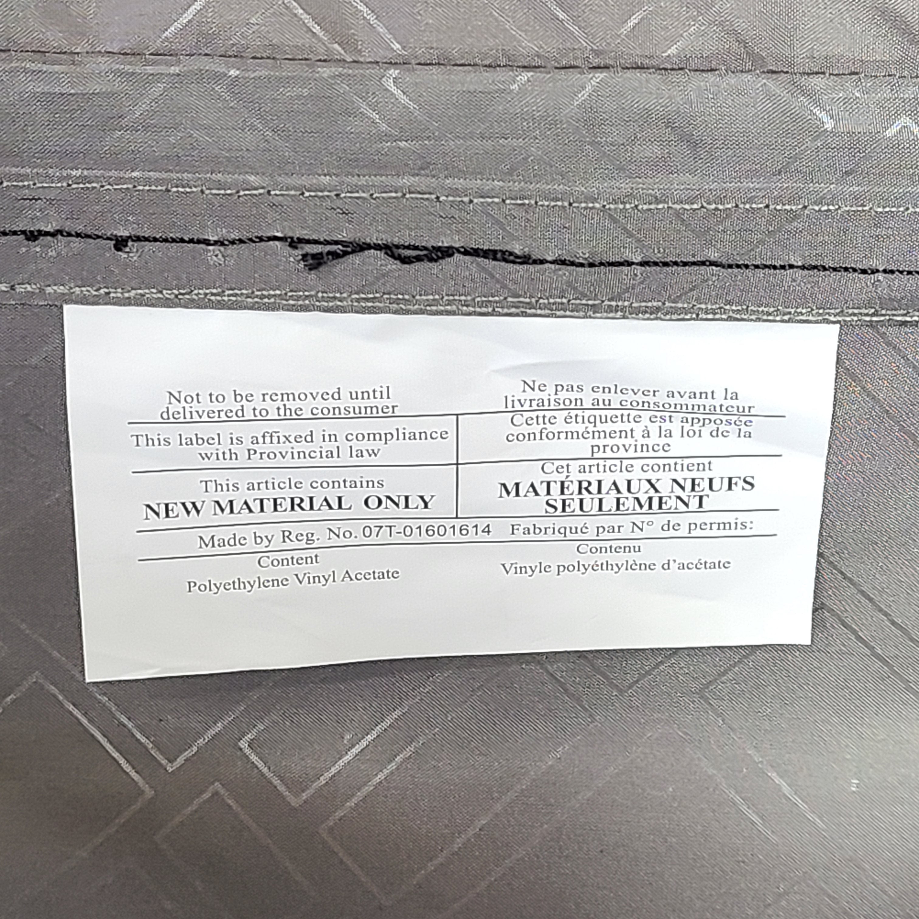 Gray ESPACE carry-on luggage constructed from polyethylene vinyl acetate with scuffs and an intact interior.