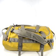 The North Face medium Base Camp duffel in yellow and grey with reinforced handles and adjustable shoulder straps.
