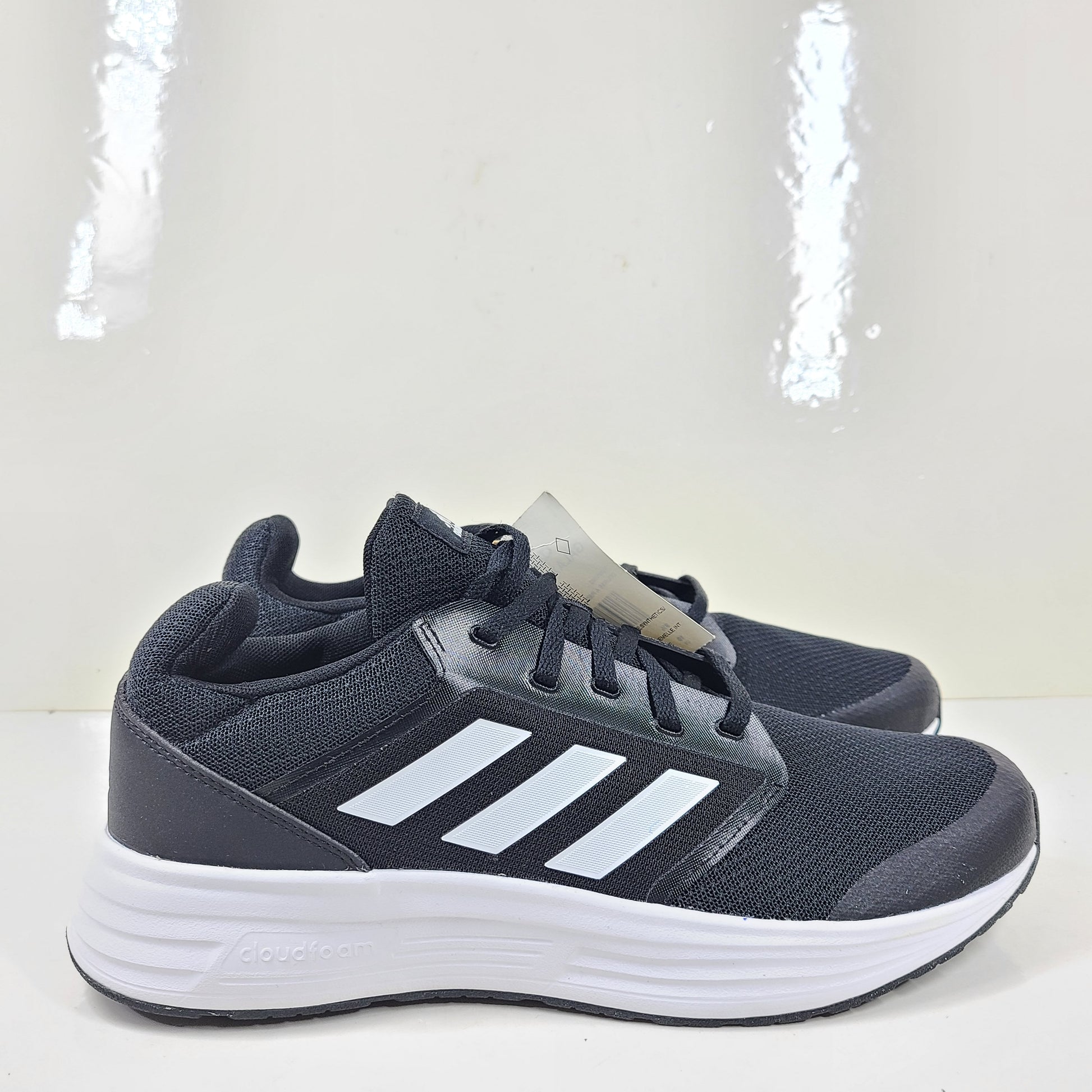 Adidas Galaxy 5 running shoe in black and white, US size 10, designed for everyday training and comfort.