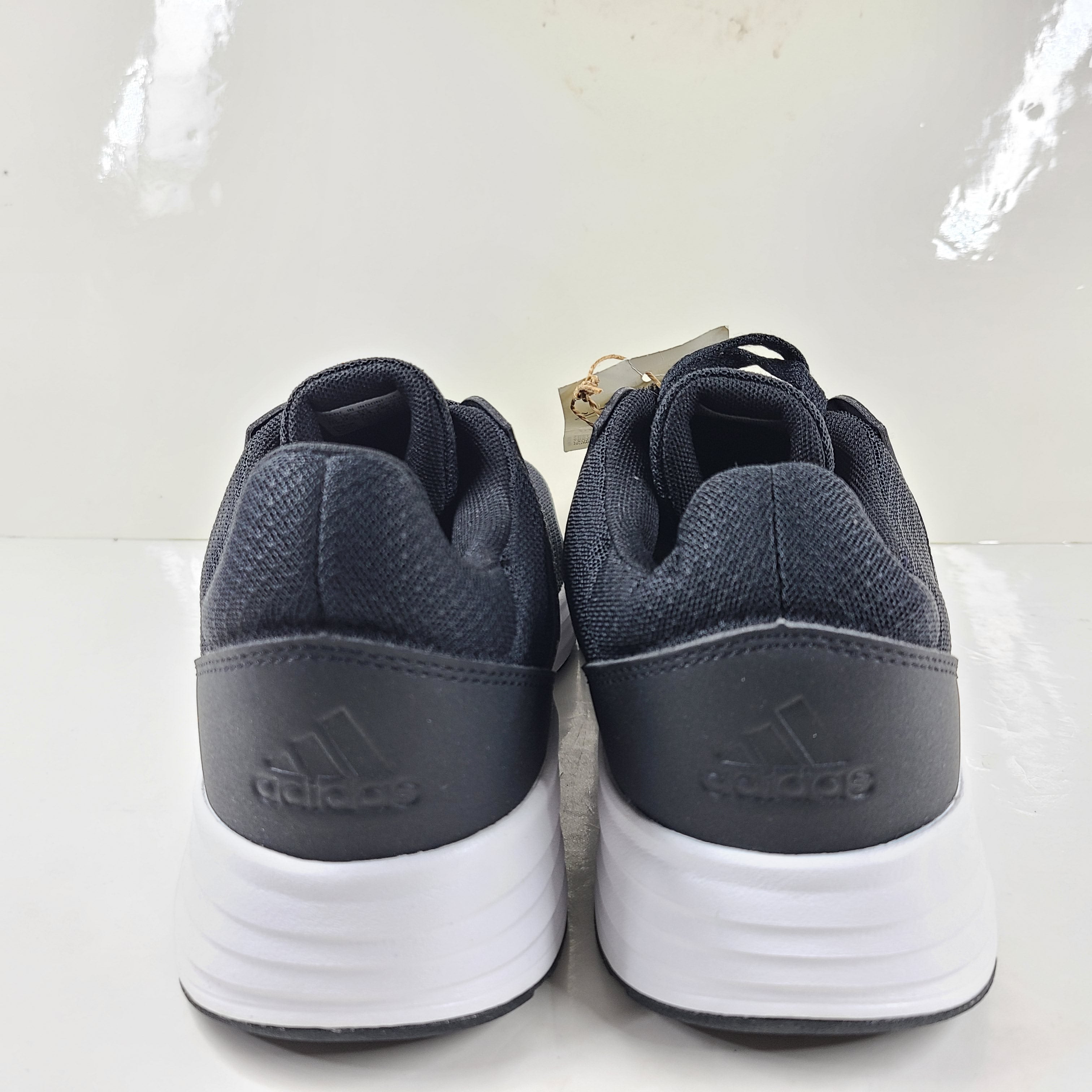Adidas Galaxy 5 running shoe in black and white, US size 10, designed for everyday training and comfort.