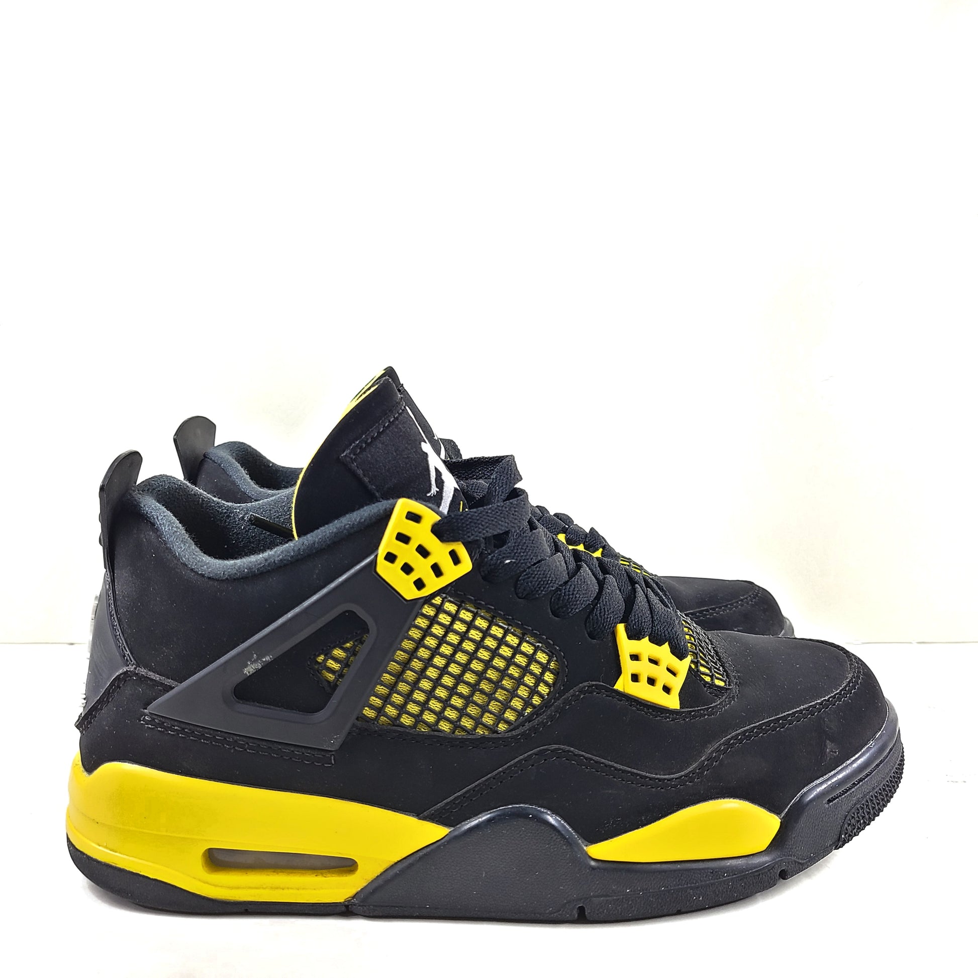 Black and yellow Air Jordan 4 Retro Thunder in US size 8 with a classic mid-top silhouette and durable rubber sole.
