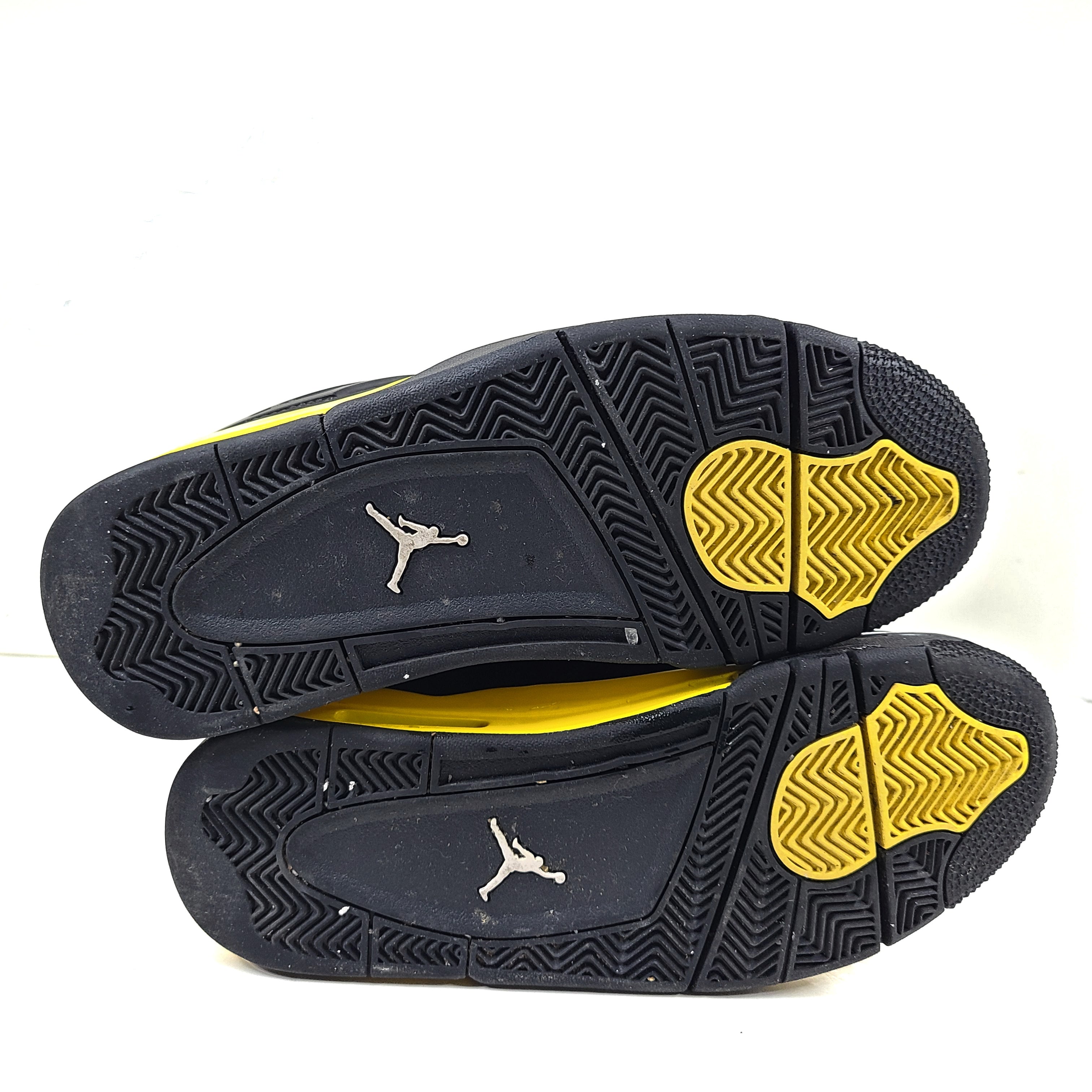 Black and yellow Air Jordan 4 Retro Thunder in US size 8 with a classic mid-top silhouette and durable rubber sole.