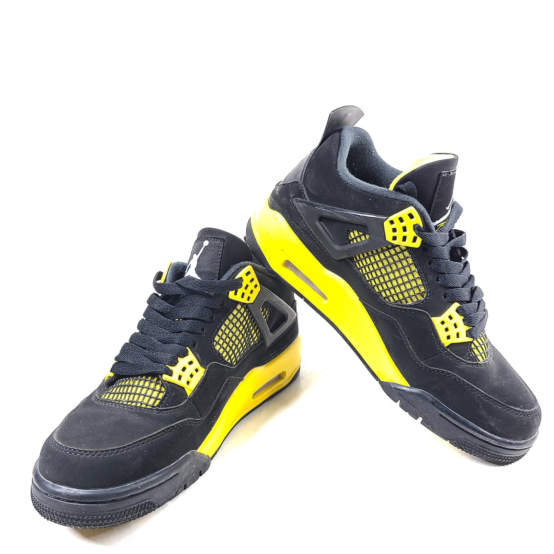 Black and yellow Air Jordan 4 Retro Thunder in US size 8 with a classic mid-top silhouette and durable rubber sole.