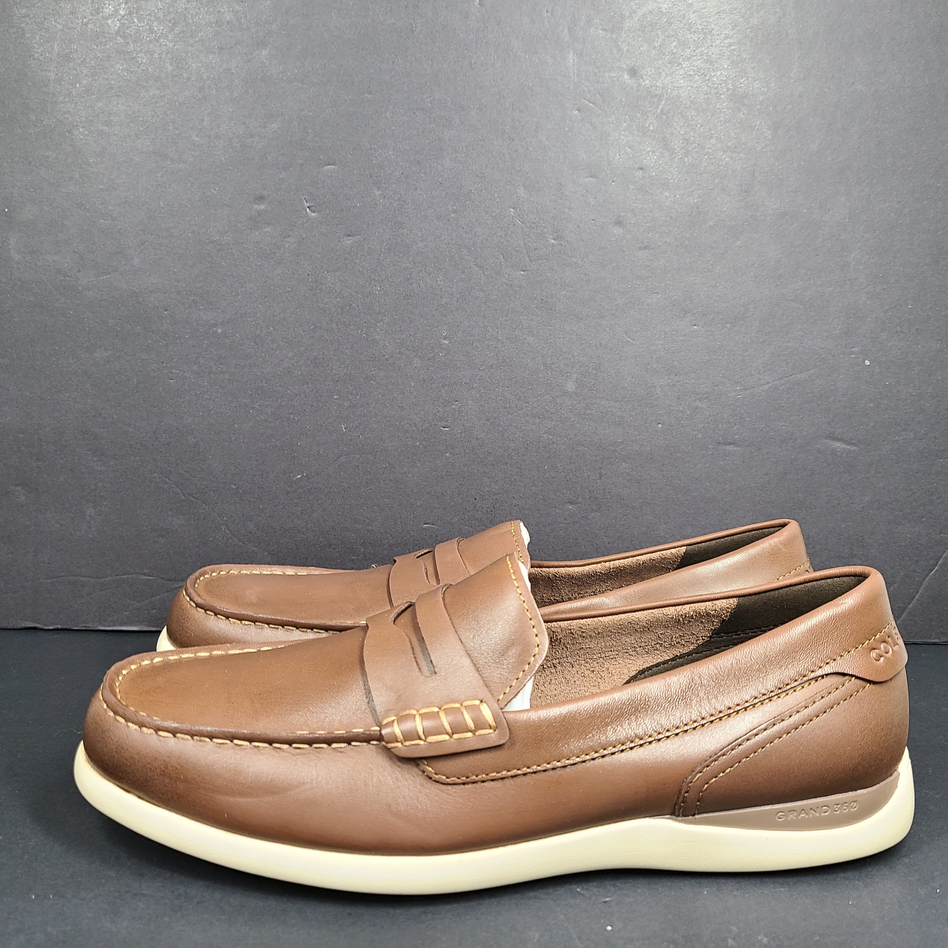 Cole Haan Grand 360 brown penny loafers size 11M, model C33028, with manmade lining.